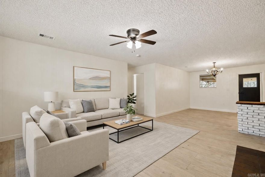 FULLY UPDATED HOME ON ACREAGE IN WEST LITTLE ROCK!! This home features 3 bedrooms and 2 fully updated bathrooms with custom tile showers, PLUS an office or bonus room. Fresh paint and LVP flooring run throughout the home. The open kitchen offers granite countertops, stainless steel appliances, and a spacious breakfast area. The living room features a wood-burning fireplace with a brick hearth and abundant natural light. Step outside to a huge covered back porch overlooking the flat backyard with mature trees and a chicken coop. If you enjoy watching deer but want the convenience of being just minutes from the highway, this one is for you.