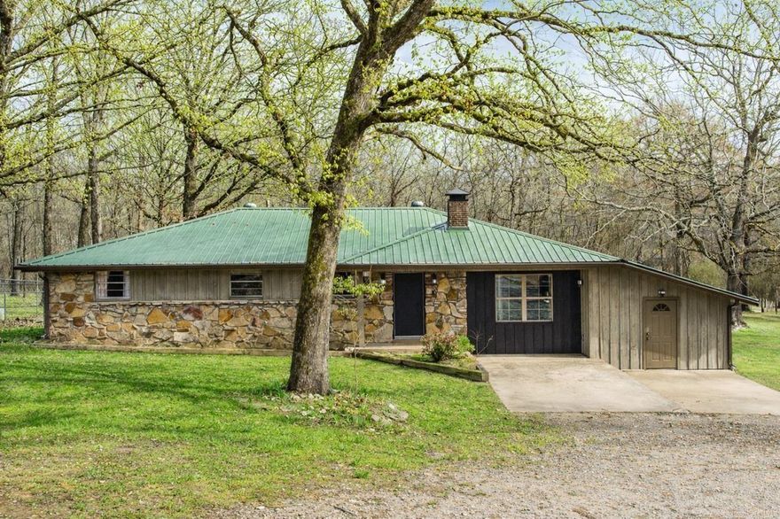 FULLY UPDATED HOME ON ACREAGE IN WEST LITTLE ROCK!! This home features 3 bedrooms and 2 fully updated bathrooms with custom tile showers, PLUS an office or bonus room. Fresh paint and LVP flooring run throughout the home. The open kitchen offers granite countertops, stainless steel appliances, and a spacious breakfast area. The living room features a wood-burning fireplace with a brick hearth and abundant natural light. Step outside to a huge covered back porch overlooking the flat backyard with mature trees and a chicken coop. If you enjoy watching deer but want the convenience of being just minutes from the highway, this one is for you.