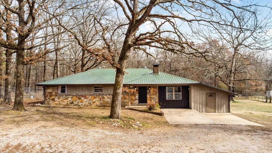 FULLY UPDATED HOME ON ACREAGE IN WEST LITTLE ROCK!! This home features 3 bedrooms and 2 fully updated bathrooms with custom tile showers, PLUS an office or bonus room. Fresh paint and LVP flooring run throughout the home. The open kitchen offers granite countertops, stainless steel appliances, and a spacious breakfast area. The living room features a wood-burning fireplace with a brick hearth and abundant natural light. Step outside to a huge covered back porch overlooking the flat backyard with mature trees and a chicken coop. If you enjoy watching deer but want the convenience of being just minutes from the highway, this one is for you.
