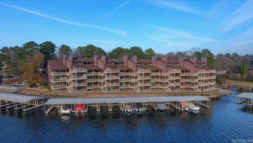 Cozy and conveniently located Lake Hamilton condo in most desirable 7 South area.  Just a few steps from parking to the your unit and this property has beautiful lake views. Also includes covered parking, swimming pool, hot tub. Immaculately maintained complex with boat slips available for rent if needed. 1 year rental minimum. Propane for gas fireplace is provided by POA. Seller is an Arkansas licensed real estate agent.