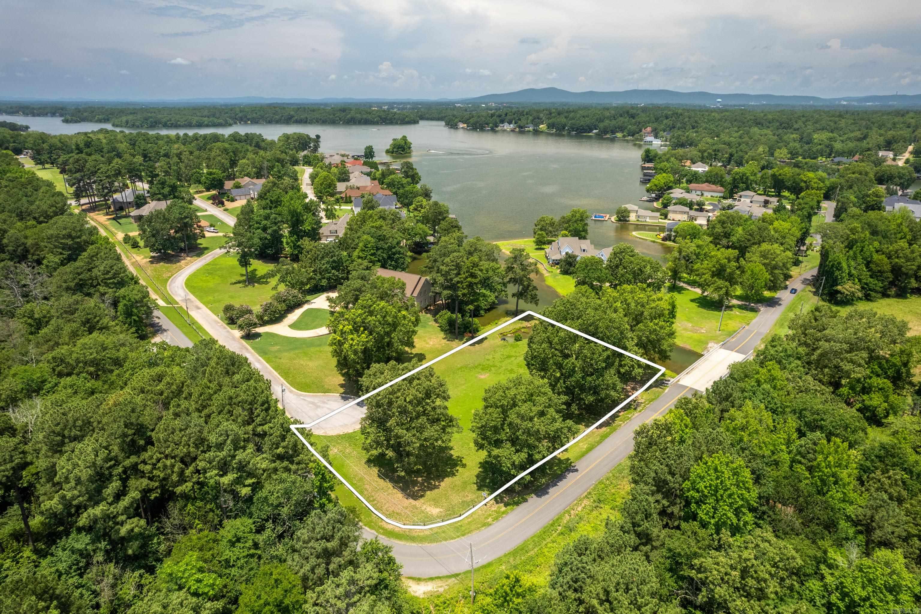 Ideal for Your Custom Build! Located in the desirable Oak Shores subdivision within the Lakeside School District, this level lot offers an excellent opportunity to build a home that fits your lifestyle. With approximately 215 feet of water frontage, the property provides direct lake access and sits among beautifully crafted homes. Enjoy access to neighborhood amenities, including a gated boat ramp, a lakeside recreation area, and secured storage for boats and trailers. All utilities are conveniently located at the street. Boundary outline in photos is for illustration purposes only and is not exact.