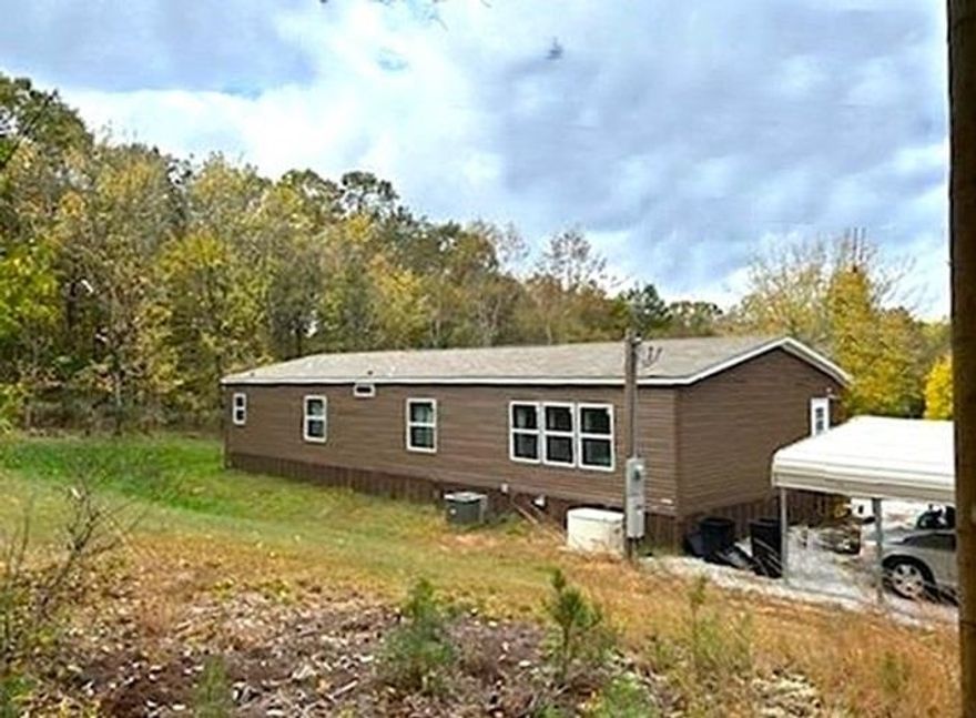 Discover a haven of seclusion, where tranquility and privacy blend seamlessly. This nearly new 3-bedroom, 2-bath home, situated on a 3.48-acre mostly wooded lot, offers an idyllic retreat from the bustle of everyday life. With 1,792 sq ft of designed living space, the home includes a den that can be tailored to your needs—whether as a fourth bedroom, a quiet home office, or a creative hobby room. Brand New deck/landing. A propane wall heater ensures you stay warm and comfortable, no matter the weather. Outside, the property features a detached two-car carport, two storage buildings, and a deer blind, making it ideal for those who love to connect with nature. The 500-gallon owned propane tank provides reliable and independent energy. Nestled between the historic charm of Mountain View and the natural beauty of the White River, this home offers a perfect balance of seclusion and convenience. Embrace the opportunity to garden, raise animals, or simply relax in the serene surroundings. Despite its remote feel, the property is just a short drive from local amenities and attractions. Shown by appointment only—experience the ultimate in peaceful living today. Call Today!