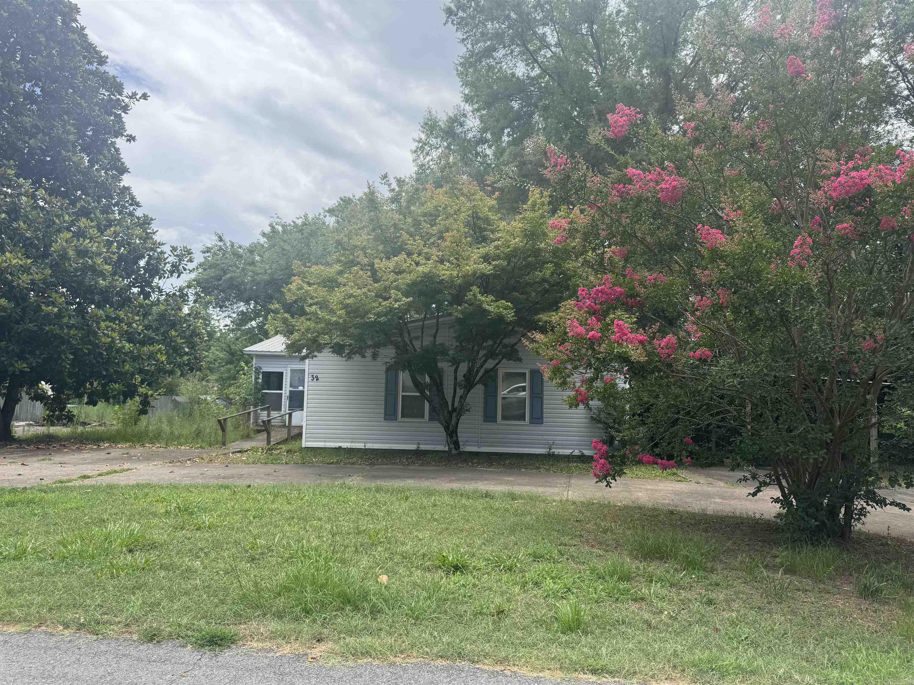 **$10K BUYER INCENTIVE! USE HOWEVER BEST FOR YOUR BUYER - UPDATES, CLOSING COSTS...** 4 bedrooms and 3 baths on the sweetest street in Conway! Mobile home with a permanent foundation. 2 lots. Roomy eat-in kitchen with French doors to the deck out back. Separate dining room. Bathrooms are large. All items will be removed before closing. Square footage provided by seller. Acreage was determined by lot dimensions. No seller property disclosure. Showings require 24 hours notice.