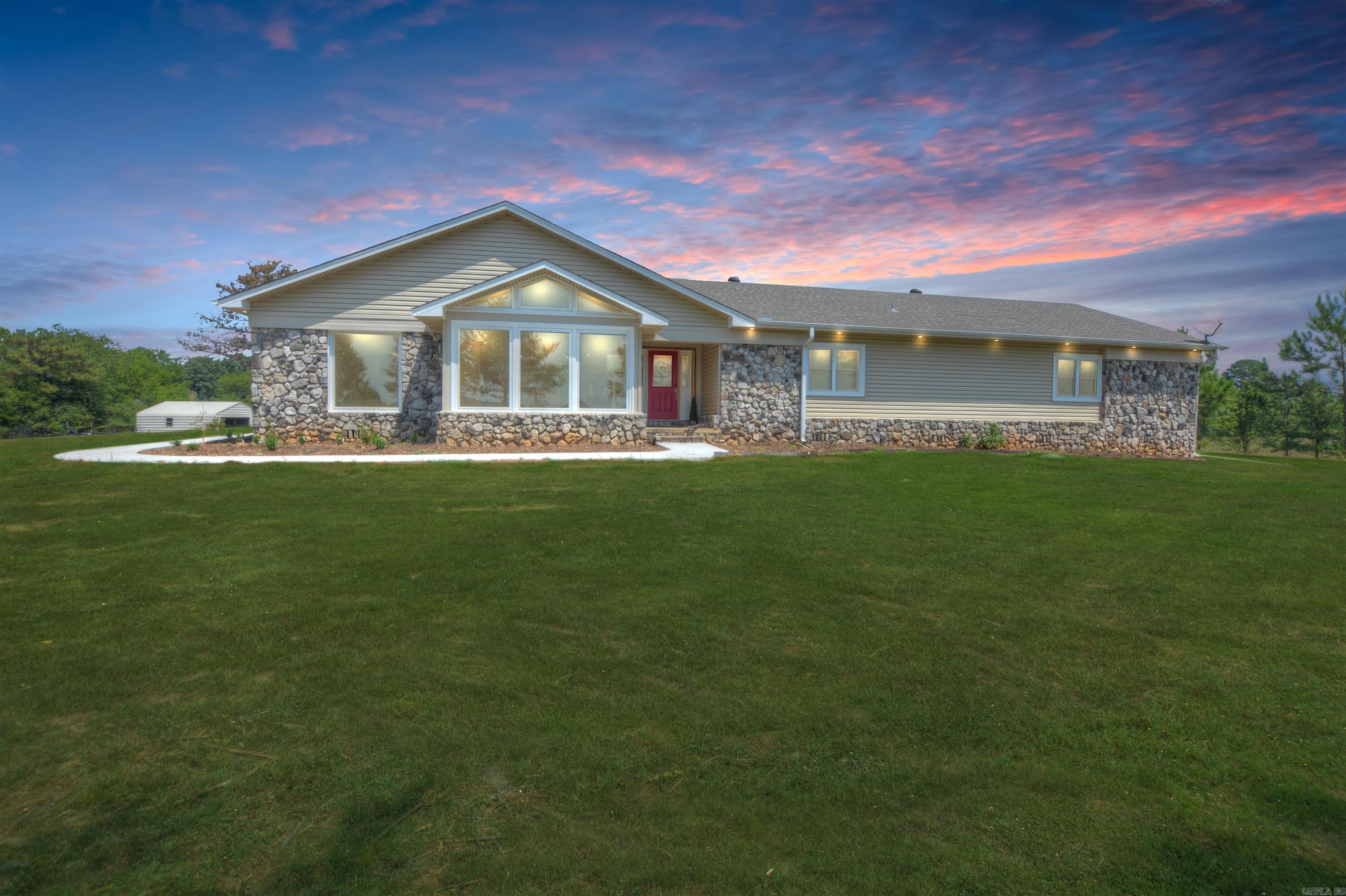 Completely updated in 2025, this 4,097 sq ft, 4-bedroom, 3.5-bath home sits on nearly 10 acres of gently rolling pasture with a 3-stall horse barn, hay barn, additional barn, and storage building. Enjoy views of a neighboring pond and surrounding hills while relaxing by the large in-ground pool, spacious covered deck, and expansive patio. The redesigned floor plan features new LVP flooring, fresh paint inside and out, a fully updated kitchen and primary bath, new plumbing, lighting, windows, and doors, plus a mini-split in the game room and a new roof in 2023. Interior highlights include a formal dining room, office, game room, sunroom, and a wood-burning fireplace with modern façade. Two-car garage, detached carport, city electricity, well water (city water available), and septic complete the package.