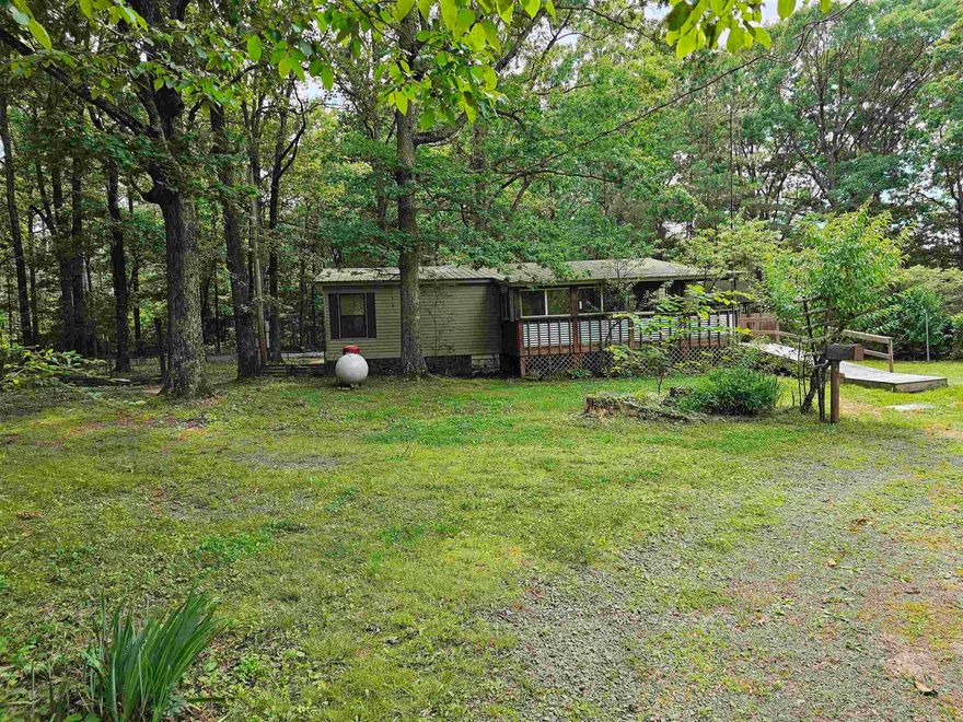 Beautiful Land with WELL-KEPT 2br 2 1/2 bath mobile home. Addition that could be used as a family room, game room, media room, or an additional bedroom. Lots of closet space. Fresh paint, nice solid oak cabinets.  Sunroom with tranquil view. Pex plumbing throughout home. Metal Roof. Handicap accessible with wheelchair ramps. Storm Shelter.  Plenty of space for animals.  Great place for a weekend getaway or a little Hobby Farm. Small stocked pond.  Plenty of Large, beautiful trees with some fruit trees. Old home located on the property is watertight. Great Garage/ Storage space with updated Electrical repair on both Garage and old home. Garage has new paint. Multiple Storage buildings.  Old well and well house. Selling Furnished. 3430 /3432 Heber Springs Road N. Tumbling Shoals Ar. 2.40 acres M/L