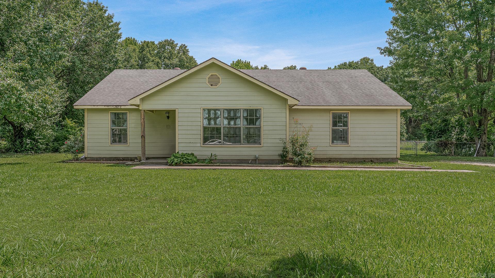 Looking for a countryside feel in a convenient subdivision setting? Let's go see 223 County Road 122, located just outside of Bono and Jonesboro in the Summerfield Homes Subdivision. With so much potential, this charming 3-bedroom, 2-bathroom home offers a spacious layout with a large kitchen featuring pretty cabinetry and French doors that open to a backyard patio. The spacious living room features three double-hung windows that provide plenty of natural light. The split floor plan includes a primary suite complete with a walk-in closet, a large jetted soaker tub, and a separate walk-in shower. On the opposite side of the home, you'll find two additional bedrooms, a guest bathroom, and a convenient laundry area. Situated on a 0.96 +/- acre lot, the property has a fenced backyard. This property has outside charm and endless potential inside. Call today to schedule a tour and make an investment in tomorrow!