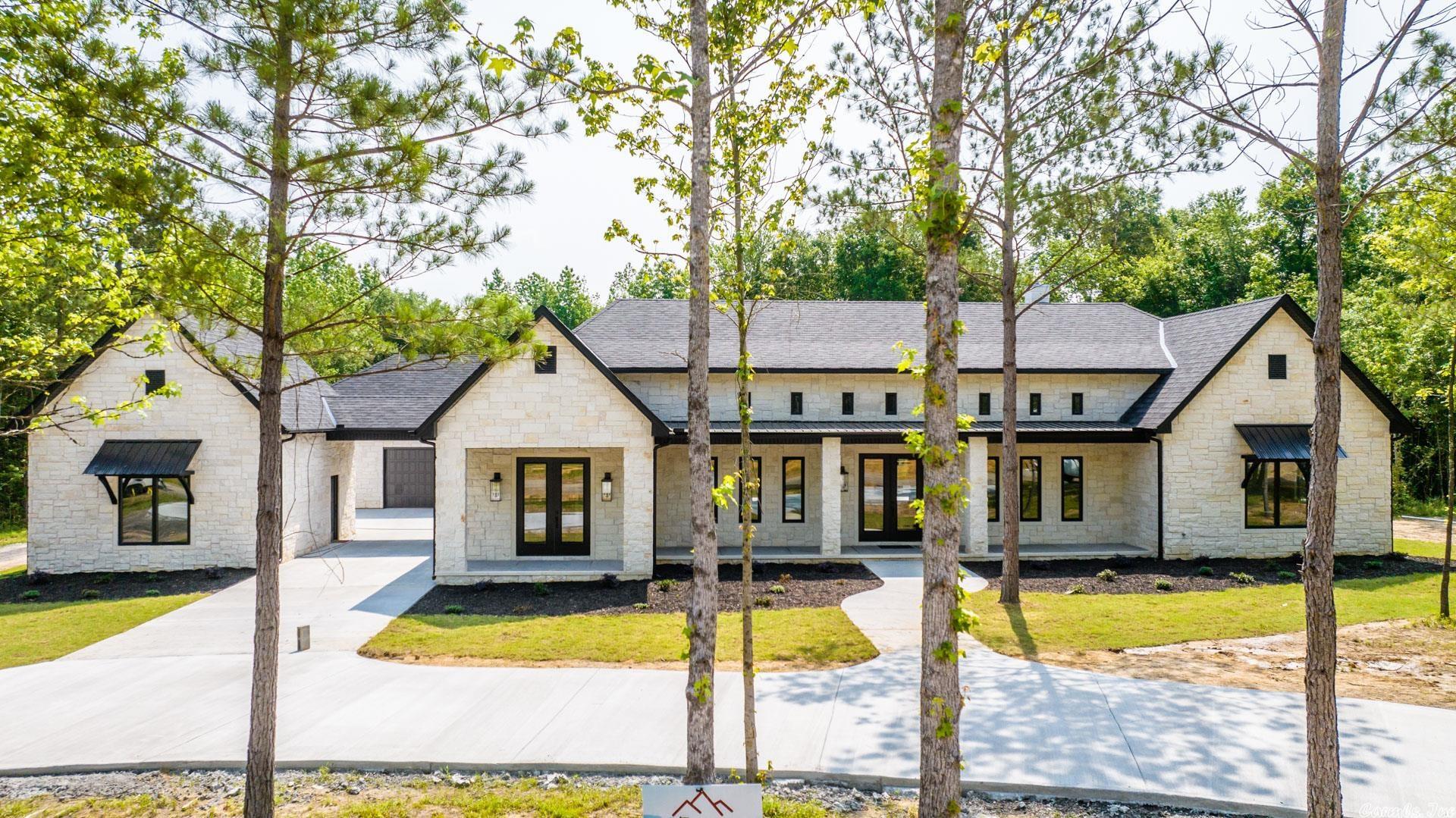 This home is situated on 3 acres & is the definition of stunning with its Texas limestone exterior & high end interior details! Upon entering the gorgeous double doors you will be met with 14' soaring ceilings & a beautiful floor to ceiling limestone fireplace w/built ins. The gorgeous kitchen will be a family gathering place around the 12' center island and includes wow features like quartize countertops, stunning light fixtures, petrified wood backsplash, professional grade appliances, tall stained cabinets, ice maker, pot filler, & pantry closet. The spa like primary bath features an oversized soaker tub & custom shower with overhead rainfall shower head. Custom safe room inside the house offers peace of mind on those stormy days & nights. The In-law/guest quarters is connected by a portico & features a kitchen, open living & full bathroom. Plenty of room for those summer cookouts or fall tailgate parties w/2 massive covered back porches...one with a fireplace and 1/2 bath. This property even has every man's dream with a 30x40 shop that's heated/cooled & includes a full bath. Too many features to list! Be sure to check out the video tour! BOMK-buyer couldn't sell their home