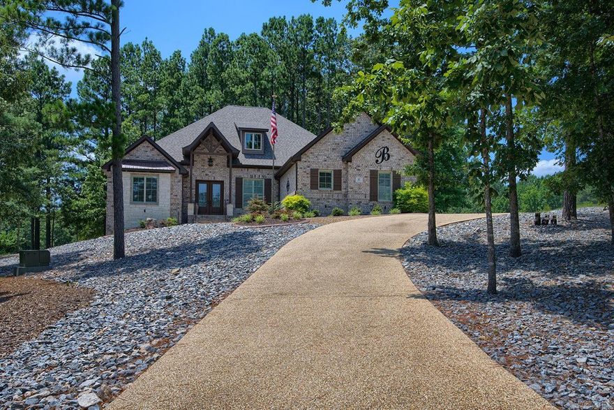 Spectacular Golf Course Estate – Hot Springs Village, AR Overlooking #3 Nina & #9 Pinta Fairways 3,300 sq. ft. | 1.22 Acres | Built in 2020 Offered at $737,000  Timeless luxury meets scenic golf course views in this custom-built estate. Set on 1.22 acres, the home features an open-concept layout with soaring ceilings, rich wood floors, and a wood-beamed great room with gas fireplace. The gourmet kitchen boasts granite counters, gas range, double ovens, walk-in pantry, and ample cabinetry. Enjoy formal dining, a breakfast area with built-in hutch, and a private guest suite on a separate wing. The master suite offers a spa-like bath and huge walk-in closet. Additional highlights include a home office with built-ins, plantation shutters, washer/dryer, interior attic access, and a 3-car side-load garage. Relax or entertain on the covered tile patio with stunning fairway views. A rare opportunity for elegant golf course living!