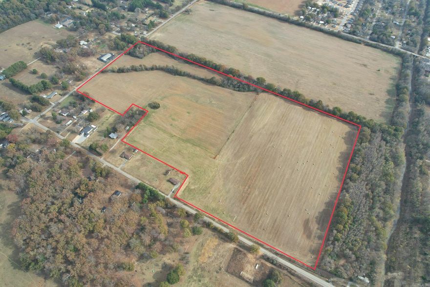 Discover the unmatched potential of this sprawling 63 +/- acre property, ideally zoned R2 for your development dreams. Strategically located with city sewer access at its most southern end, this property is perfectly poised for significant residential development. With the convenience of natural gas and electric services bordering the western and northern peripheries, infrastructure setup is streamlined, ensuring a smooth start to your project. Although the southern third of the acreage is within a flood zone, innovative solutions such as a retention/detention pond coupled with strategic dirt work from the northern half can efficiently mitigate this concern, unlocking the full potential of the land. This property is ripe for transformation into a vibrant residential neighborhood or a lucrative residential rental complex, with the feasibility of constructing up to 4-plex units, catering to a diverse range of housing needs. Boasting complete access to all city utilities and situated just minutes from the bustling heart of downtown Jonesboro, this property offers the perfect blend of convenience and opportunity.