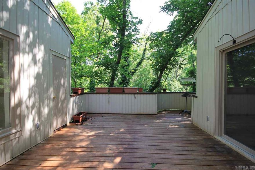 Exciting contemporary in private setting a the end of a cul-de-sac.  Lovely views into the treetops from the house and decks  Has workshop/office, two car garage, 310 sf heated & cooled office & 1/2 bath not in approximate square footage. Seller is going to replace roof & remove dead tree next to house.  Other than that, property is to be sold as is (estate settlement).