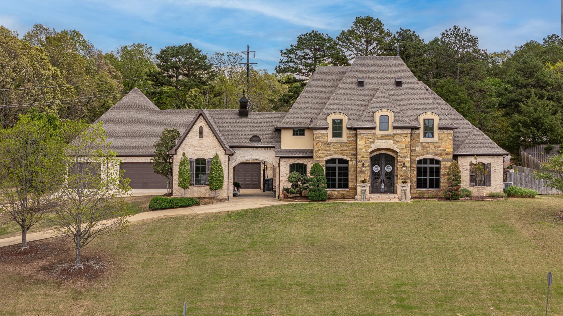 Welcome to luxury living in the heart of Dunwoody Estates in Jonesboro. This stunning 3-story estate offers an abundance of space, comfort, and high-end features perfect for entertaining and everyday living. With 6 spacious bedrooms and 7 bathrooms (5 full/2 half), this home is designed to accommodate with ease. The main level features a bright and open living room, a cozy sunroom, and a gas log fireplace that adds warmth and charm. You'll also find a dedicated office and workshop, offering plenty of flexibility for work or hobbies. The kitchen includes a breakfast bar, gas appliances, and flows seamlessly into the main living areas ideal for hosting family and friends. Downstairs, enjoy your own private movie room, perfect for movie nights or game day. Step outside to your private backyard retreat, complete with a heated saltwater pool and hot tub, an outdoor kitchen and bar, and a screened porch. The backyard is fully fenced, creating a private, relaxing atmosphere on the nearly one-acre (.92) lot. With a 6-car garage, there's plenty of room for vehicles, storage, and more. This exceptional home offers space, privacy, and luxury in one of Jonesboro's most desirable neighborhood.