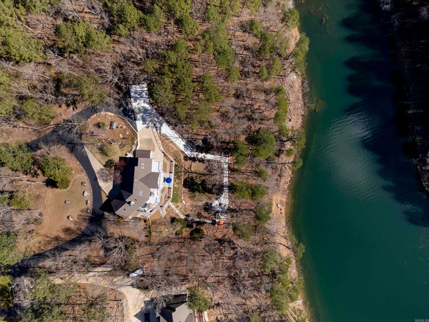 **LAKEFRONT on Greers Ferry Lake where every room has a view! This stunning 4656 sf home boasts breathtaking views and luxurious amenities, perfect for those seeking tranquility and comfort by the water. Nestled on the shores of Greers Ferry Lake, this spacious residence features: 5 bedrooms, 4.5 baths, & 2 living areas..  For all the cooks in the family, this kitchen is spacious and ideal for entertaining. Downstairs you will find an additional kitchen, living area and dining. Other features include a separate laundry room, central vaccum, 2 car garage, circle drive, landscaping and so much more.  Step outside onto the spacious deck and soak in the beauty of Greers Ferry Lake. With panoramic views and plenty of space for outdoor dining and lounging, this deck is the perfect spot to unwind and enjoy the serenity of lakefront living.  Boat launch an picnic area for neighborhood enjoyment. Escape the hustle and bustle of everyday life and experience the ultimate lakefront lifestyle at this exquisite Greers Ferry Lake home. Don't miss your opportunity to make unforgettable memories in this idyllic retreat. Schedule your personal showing today!