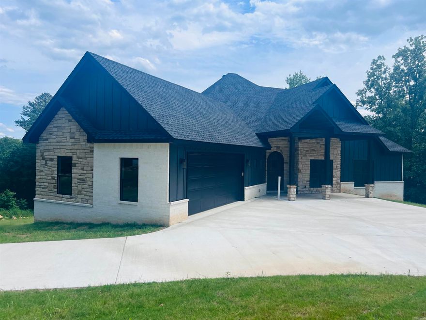 Welcome to your dream home! This stunning new 3,494 square foot lakefront property boasts an inviting open floor plan that seamlessly connects living spaces, perfect for both relaxation and entertainment. As you enter, you'll be greeted by expansive 8-foot glass doors that lead to a covered porch, providing breathtaking views and easy access to the serene outdoors. The gourmet kitchen is a chef's delight, featuring a 36-inch gas stove and high-end appliances, complemented by an impressive 8 x 8-foot walk-in pantry complete with a wine cooler. The Coretec LVP floors throughout the main level add an elegant touch and durability. The primary suite offers a luxurious retreat, featuring a spacious bathroom and an expansive 13 x 17 closet, ensuring ample storage for all your needs. The lower level boasts a walkout basement, complete with a full family room, a wet bar area w/ wine fridge, a bathroom, and an additional bedroom, making it ideal for guests or a cozy movie night. With soaring ceilings of 12 feet and 14 feet, this home feels bright and open, marrying indoor and outdoor living effortlessly. Don’t miss the opportunity to call this beautiful lakefront sanctuary your own!