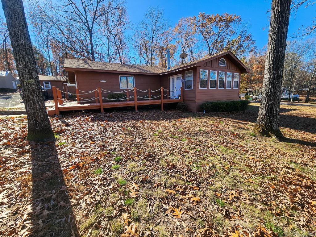 This charming 3-bedroom, 3-bathroom home in Greers Ferry is beautifully updated and situated on a spacious .72-acre corner lot. With 1,880 square feet of living space, each bedroom enjoys its own private bathroom, offering ample space and privacy for family and guests. Recent renovations include a brand-new HVAC system installed in 2024, ensuring year-round comfort. The roof, dishwasher, and screened back porch were all updated in 2023, while new flooring and fresh paint throughout the home add to its appeal. The front bathroom was remodeled in 2021, and the kitchen and primary bathroom have also received modern upgrades. A new chip & seal driveway was completed in 2018, providing convenient access around the house. Step inside to discover a heated and cooled enclosed front porch for year-round enjoyment, and an open-air back porch with vaulted ceilings perfect for relaxation. The large living room is ideal for gatherings, while the 2-car garage and additional shop building with electricity offer plenty of storage and workspace. Located just three streets away from the scenic Greers Ferry Lake and close to Westside School, this home presents a fantastic opportunity for comfortabl