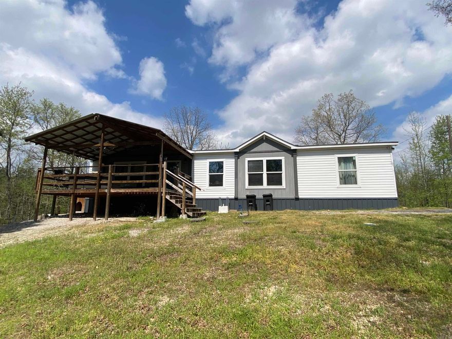 Come be a part of our Lake Ouachita community!  Welcome to 47 Hawkeye Lane, a lovely 3 bedroom, 2 bath double wide manufactured home with 1568 square feet.  This 2019 model home sits atop 4.25 acres overlooking a wet weather creek.  Luxury granite countertops in the kitchen, large soaking tub and double shower in the master bath, a built-in entertainment center are just a few of the fashionable upgrades you will enjoy.  Just a few miles from Lake Ouachita and close to Mount Ida in Williams Creek Estates, a local rural subdivision, you will have room to roam and enjoy the mountain views.  Property features city water, septic and outdoor storage building along with a large covered deck for relaxing.  Furnishings are negotiable. Call today to view this awesome place!  $269,900.00