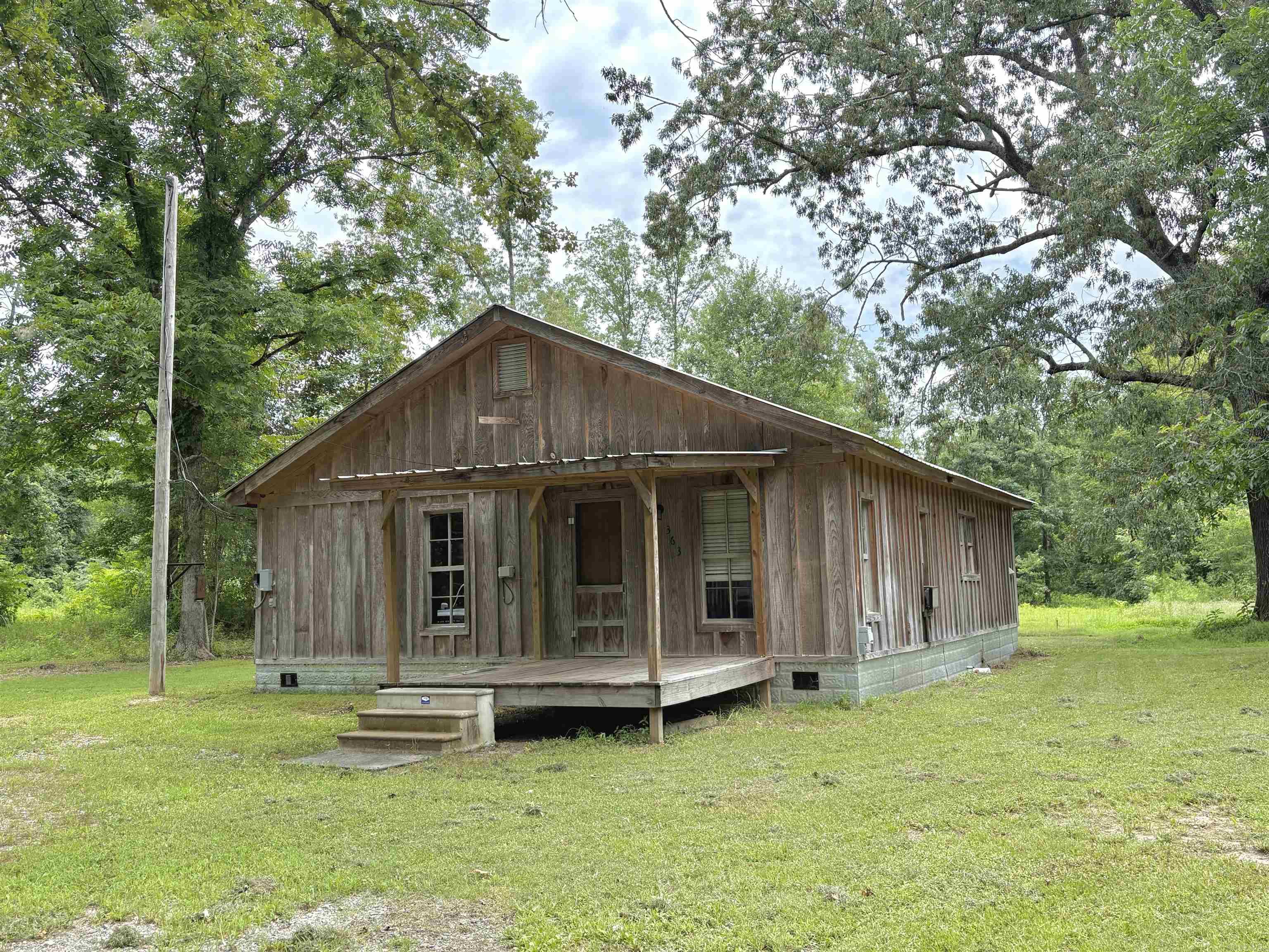 Escape to your own peaceful retreat in the heart of nature! This 3 bedroom 1 bath cabin offers 1,054 sq ft of cozy living space nestled among the woods. Step inside to find a spacious kitchen (gas stove-propane tank conveys), walk in shower in the bathroom as well as laundry area. Sip on your morning coffee and watch deer in your backyard. Buy it with 5 acres for just $89,000 or expand your space and privacy with 13 acres for $134,900. Property sold as-is