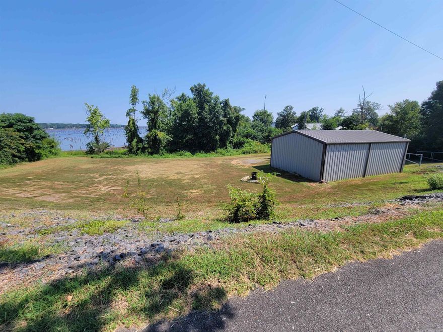 Discover the ultimate retreat with this stunning .87-acre lakefront property, offering a rare combination of natural beauty and modern convenience. Enjoy approximately 100 feet of pristine lake frontage, perfect for relaxation, fishing, or simply soaking in the serene views. At the heart of this property is a spacious 25' x 40' fully insulated shop, built in 2019 to the highest standards. With 12' walls and two large 10' x 8' doors, this versatile space is ideal for any project or hobby. Inside, you'll find both 110V and 220V power, accommodating a wide range of equipment and tools. The shop is also plumbed for a bathroom, adding an extra layer of functionality and comfort. Additionally, the property comes with a septic permit already issued, simplifying your planning and development process. Whether you envision a charming lakeside home or a weekend getaway, this property provides a solid foundation and endless possibilities. Don’t miss out on this exceptional opportunity to own a slice of lakefront paradise with all the modern amenities you need. Schedule your viewing today and start envisioning your future here!