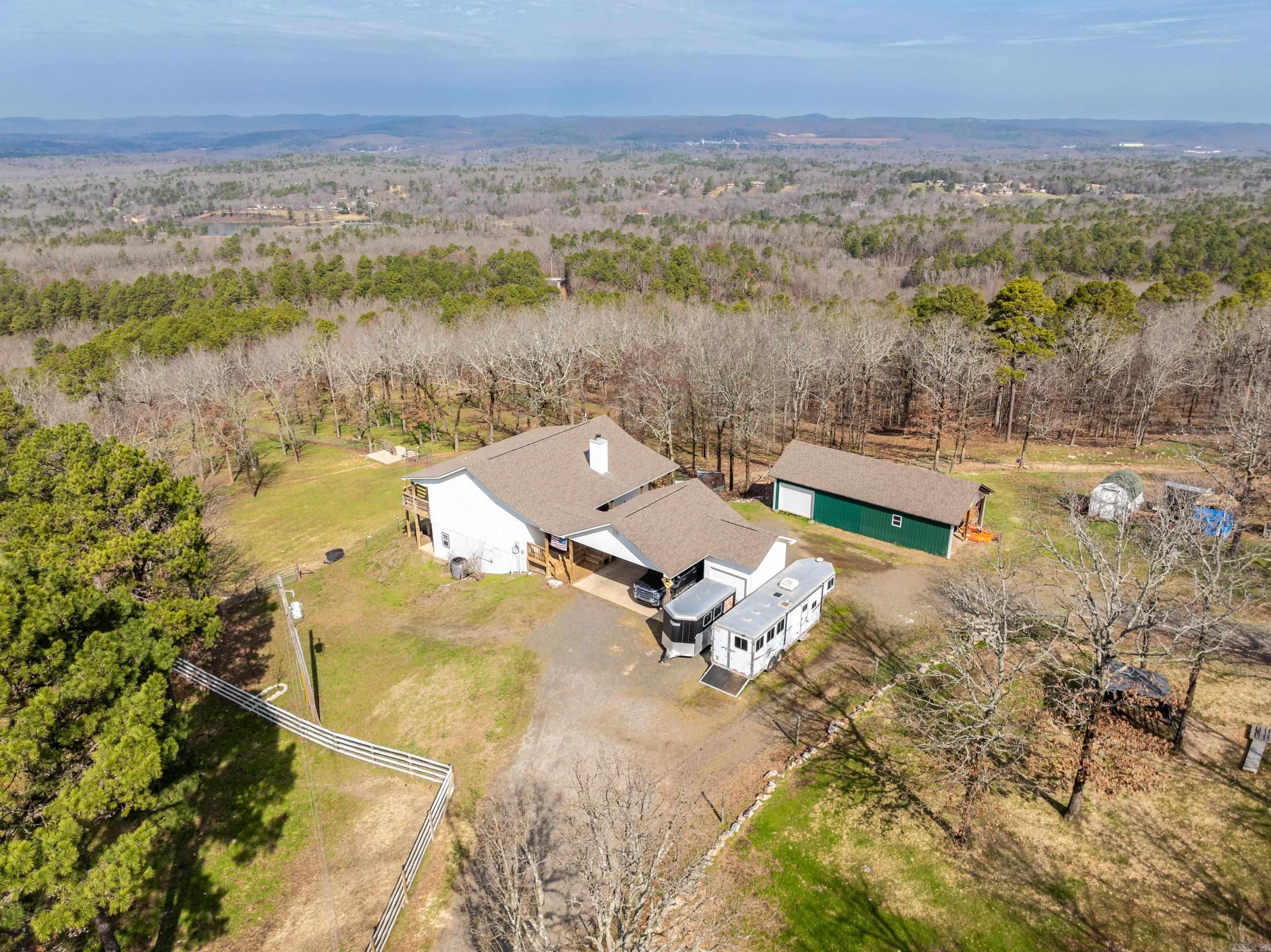 Sellers are offering buyers paid concessions up to $10,000.00 NOW is YOUR time to enjoy YOUR very own MOUNTAIN TOP HOME! ENJOY the majestic views! and tranquility! If you're looking for country living close to Hot Springs National Park and Lake Catherine State Park, this home is for you! City convenience yet located just outside the Hot Springs city limits! Located in the gated Diamondhead South area. Sprawling ranch style home with walk out basement! Very open floor plan - spacious living with a cozy fireplace, plus Master suite up. Lower level: 2 Bedrooms 1 & 1/2 bath, laundry room, and game room all with lower level outside access. Attached 2 car carport and storage building. Separate Shop approx 20x40 1/2 enclosed and 1/2 covered/open. Acres 13 (MOL) Fenced and cross-fenced with water on demand in some pastures, chicken coop. Breathtaking views, serene natural living. Don't miss this opportunity!!