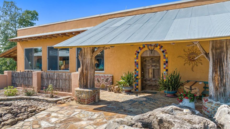 Unique, Stunning, One of a Kind & Beautiful are just a few of the adjectives you would use to describe this amazing property. Truly one of a kind in every aspect. The main dwelling is a unique architectural design developed by architect Michael Reynolds called an “Earthship”. Earthships are designed to behave as passive solar earth shelters made of natural & upcycled materials such as earth-packed tires, cement, bottles & cans to create a unique concept for energy savings. Totally off grid but with any household electrical amenities needed. Solar panels, diesel generator, propane generator & well water makes this property totally grid free. The main house has 4662 sq ft with unique custom designed architectural features throughout as well as an impressive custom designed kitchen with ample space for dining and entertaining.  Other features of the house include a huge living room with custom built fireplace,  2 “open” bedrooms, 1 ½ baths with composting toilets, covered front porch & covered patio. Property also includes a 892 sq ft guest house/dog kennel, huge cabana, 4 bay garage w/ office area/hobby shop & summer cottage. Too many features & many more pictures . Call for details.