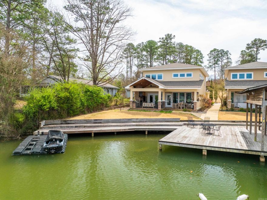 Discover this beautiful home on Lake Hamilton! Impeccably maintained, this rare opportunity features a practical layout with two master suites and an outdoor space ideal for entertaining or unwinding, all with breathtaking lake front views. The property includes a boardwalk with tie-ups, access to a boat ramp, and allows nightly rentals without needing a short-term rental permit. This won't last long! Schedule your showing today!