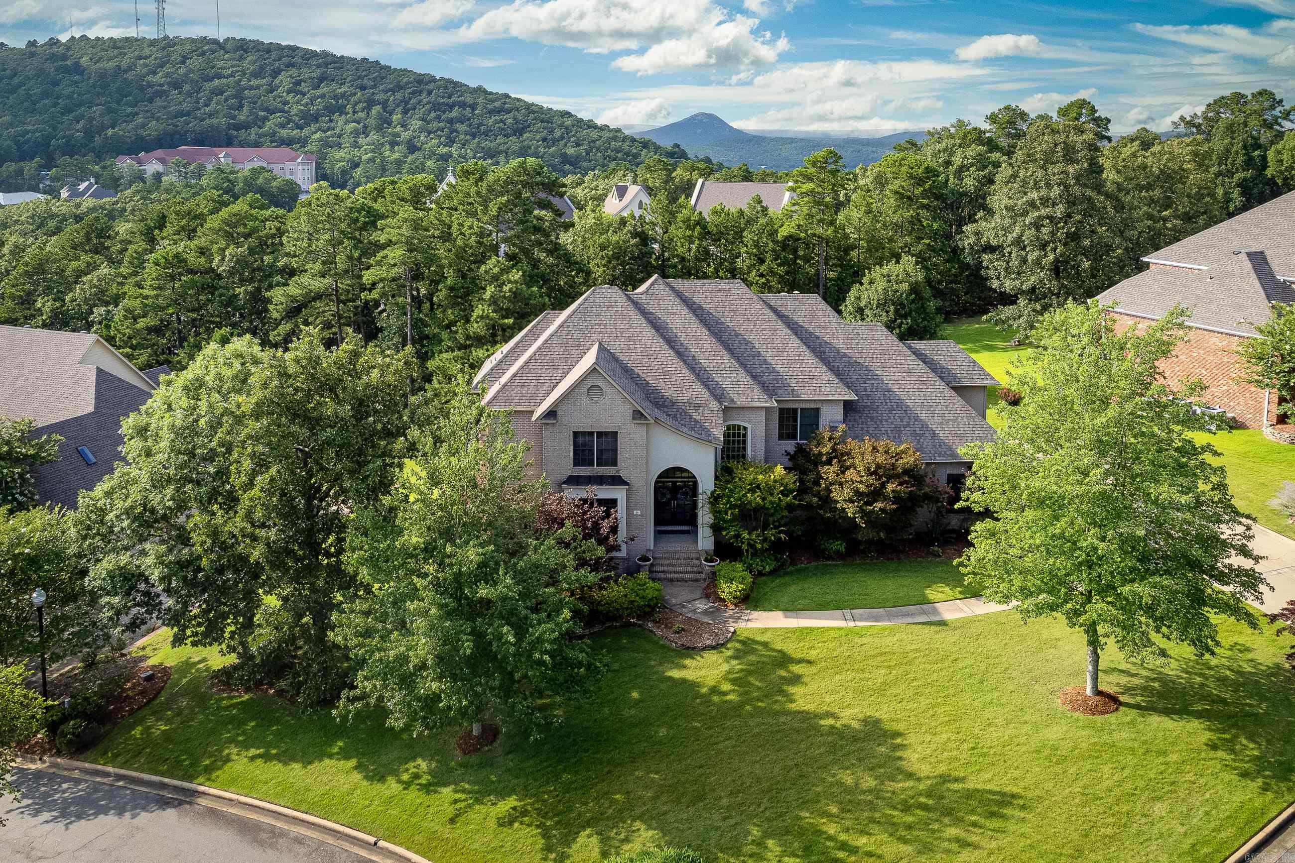 Stunning Chenal Home with POOL!! This lovely estate offers every luxury you can imagine plus the best curb appeal in all the neighborhood. Upon entering you are immediately greeted by a gorgeous light filed entry-way. Handsome hardwoods lead you to a gourmet kitchen and family room combo complete with slab granite, custom cabinetry and premium appliances. High ceilings, french doors and tall windows also compliment the space and give the home an airy spirit. Downstairs primary suite offers an elegant bath and custom closet with built-ins. The grandiose stairway is complemented by wrought-iron spindles and leads to a magnificent open balcony bridging the 3 upstairs bedrooms and giant game-playroom. The Exterior.... is second to none!! Enjoy summer pool-time and cookouts, watch fall sports w/ roasted marshmallows by the outdoor fireplace or simply relax with a cozy cocktail while admiring a majestic sunset. This home absolutely has it all!! Agents See Remarks