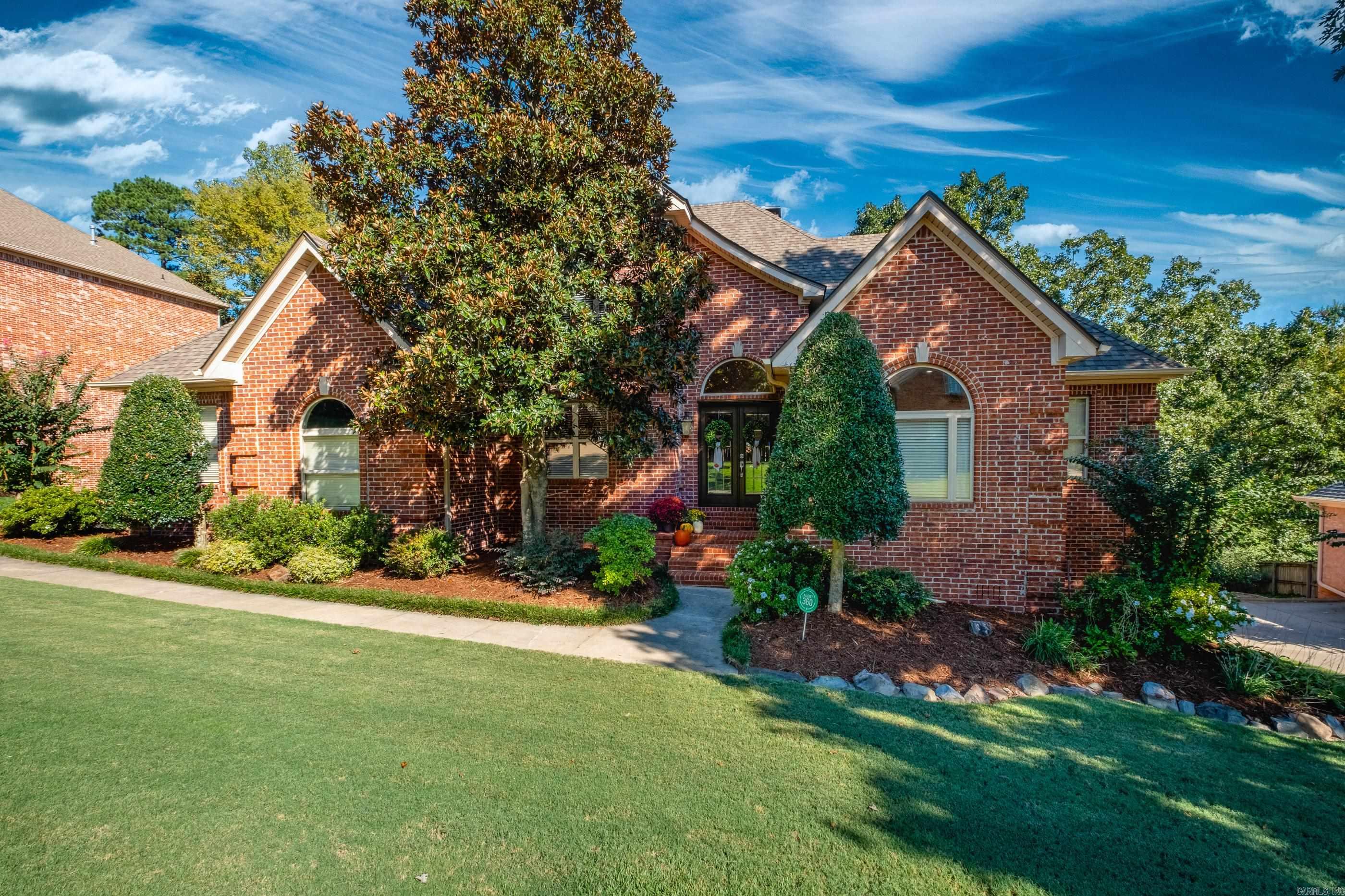 Meticulously maintained Chenal Valley home. Inside, the home feels practically new with designer-curated finishes that bring style and sophistication to every room. Beautiful hardwood flooring and tile flow throughout, offering both beauty and durability. The first floor features the family living spaces including a formal dining room, office, great room with fireplace and kitchen with breakfast room. The primary suite is on the main level and 3 additional bedrooms plus a flex room are upstairs. Whether you're sipping coffee in the morning or relaxing at sunset, the double-stacked deck is the perfect place to take in the scenery. Don't miss this gorgeous home in the spacious Margeaux neighborhood of Chenal Valley.