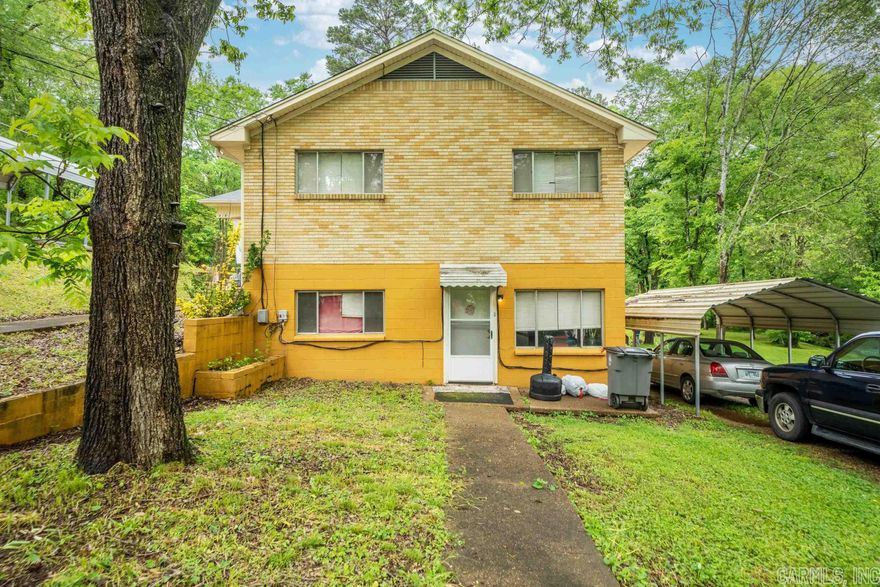 Attention Investors!! Duplex in the cirty with long term renters.  Both units are 3 bedrooms 2 baths each with a designated carport.  There is one extra carport with storage building as well.  This is a solid house with brick exterior.  The property is beautiful and very close to the greenway with a stream that runs through the backyard.  Only 2 miles from Oaklawn Racing and Gaming.  Great income potential.  The seller would consider owner financing.   Schedule an appointment today