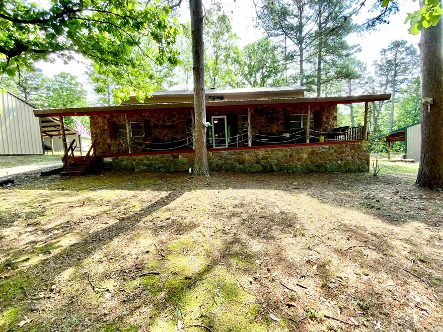 2 Lots for the price of 1!  Arkansas fieldstone lake house - perfect for weekend getaways. Four bedrooms down with a spiral staircase to a large sleeping loft. Great room with stone fireplace converted to propane that could easily be converted back to wood burning. Open kitchen area, two full bathrooms, fully screened back porch and covered front porch. This house sits on Lot 25. The adjacent Lot 23 has the shop of your dreams! Huge 30x50 building has three oversized bays with tall garage doors to accommodate even the tallest pontoon boat and extra room for all of your other toys. There is a large workbench area ready for the handyman/handywoman. It also boasts a 14x50 covered area in back, perfect for storage or BBQ's. ALL FURNISHINGS STAY and you can be on the lake in minutes!