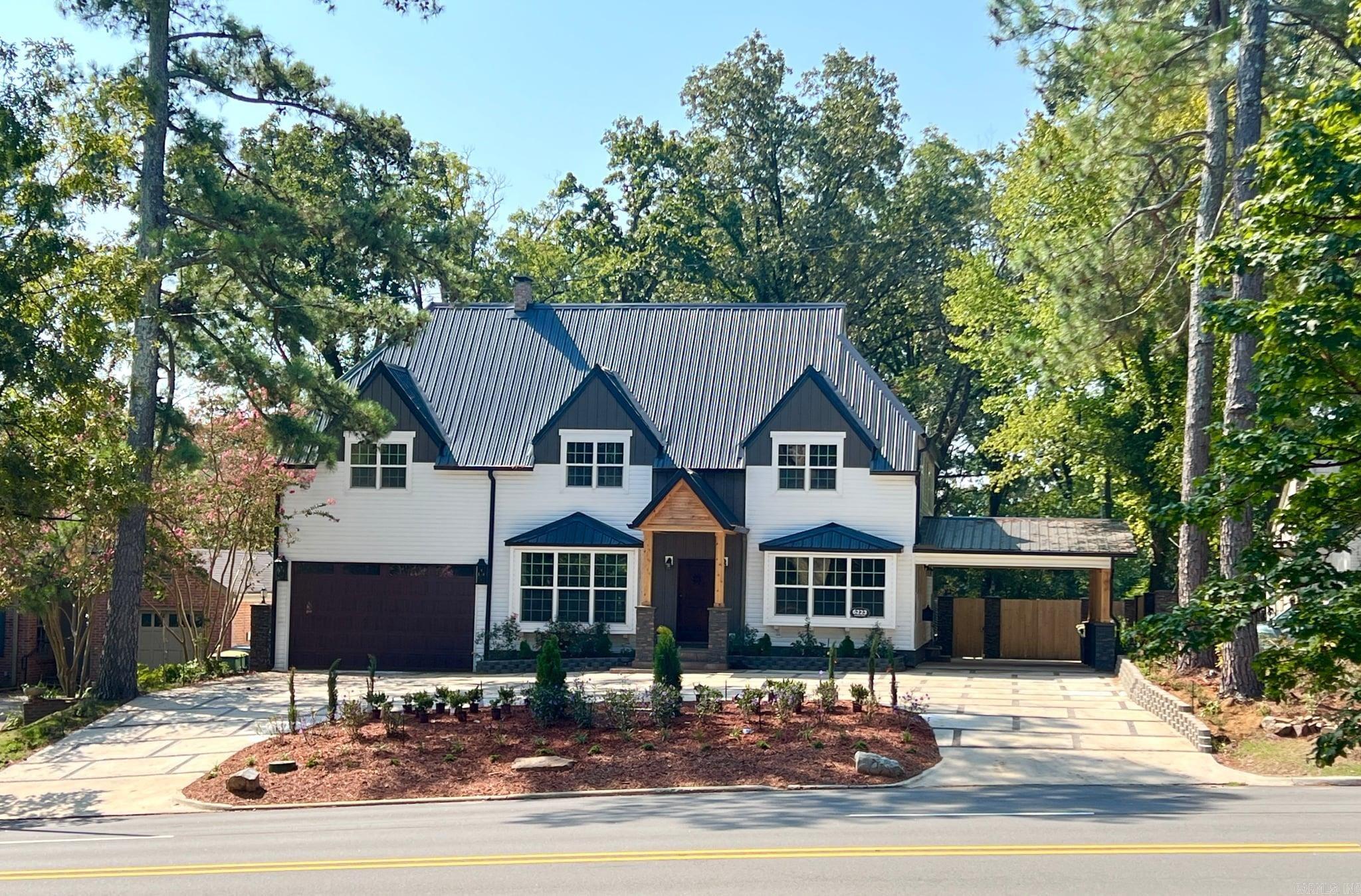 Welcome to your dream home! This stunning 5-bedroom, 5.5-bathroom masterpiece is a custom-built oasis that checks all the boxes for luxury and comfort. Step inside to discover exquisite custom cabinets that perfectly complement the extra-large kitchen, with two dishwashers, two drawer microwaves at the center island with water fall Quartz, commercial gas oven, two side by side fridges, large separate walk-in pantry with plenty of cabinets, featuring gleaming quartz countertops that will inspire your inner chef. A separate office with custom cabinetry and large bay windows. There is an abundance of windows in each and every room to bring in the natural light to brighten each space. Every window is wrapped with decorative wood casing and header molding. The primary suite is truly a retreat of its own, wood vaulted ceilings, offering a separate sitting area where you can unwind after a long day. Colorful reclaimed wood flooring covers the primary suite and second level hallway. The remainder of the dwelling has hardwood flooring and custom selected tile flooring. Every room has stylish crown molding and premium wood base. The primary bathroom is nothing short of an oasis,