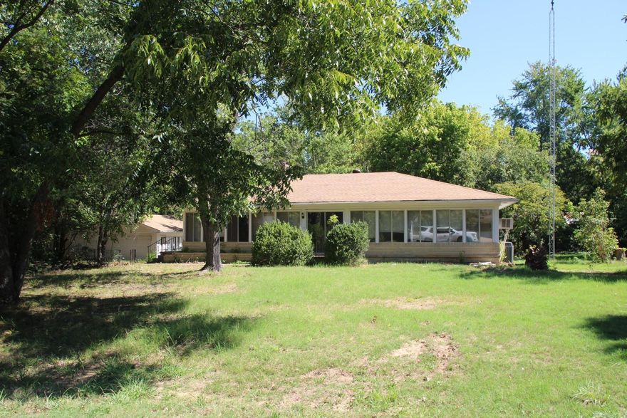 Check out this home perfect for a get-a-way or full time home only minutes to the Bull Shoals Lake or White River.  This brick two-bedroom, two bathroom home needs some TLC. This home has a large unfinished basement. Four season room off the living room and original oak floors in the bedrooms. 24x34 detached garage/shop to store your boat and all on just under 1 acre.