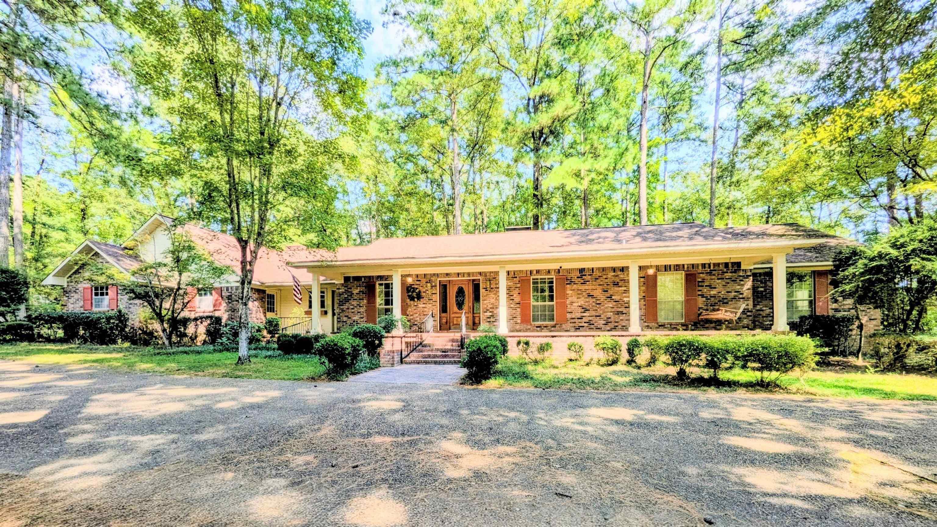Welcome to 125 Emerson Place! Nestled in a serene, wooded setting, this 4-bedroom, 3-bath home offers the perfect blend of privacy, comfort, & functionality. The spacious den features large picture windows that fill the room with natural light & overlook a lush forest and open onto an expansive deck – ideal for entertaining or simply enjoying peaceful views. The primary suite is a true retreat with its own fireplace & private access to the deck. A large game room adds even more space, featuring beautiful pine flooring, a custom tile bar, & a striking stone accent fireplace. This property also includes a 2-car garage and a 25x35 shop with electricity – perfect for hobbies, a home business, or additional storage. Located just outside city limits and minutes from shopping, dining, & medical services, and within the Camden Fairview School District, this home offers both privacy & convenience. Don’t miss your chance to own this unique home. With a smart layout and tranquil surroundings, this home is a rare find.