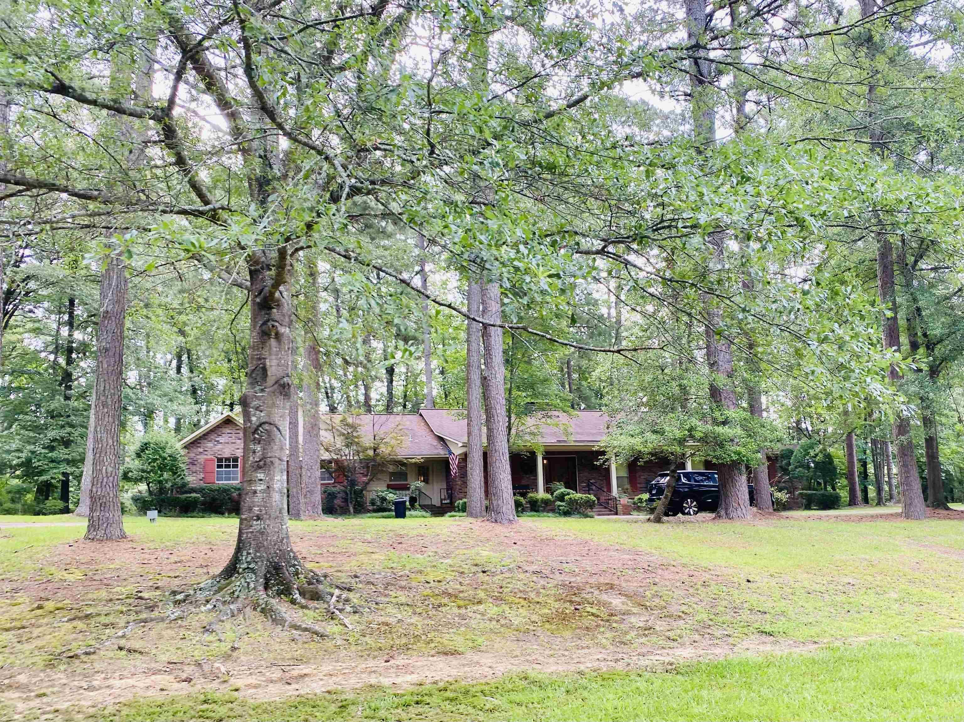 Welcome to 125 Emerson Place! Nestled in a serene, wooded setting, this 4-bedroom, 3-bath home offers the perfect blend of privacy, comfort, & functionality. The spacious den features large picture windows that fill the room with natural light & overlook a lush forest and open onto an expansive deck – ideal for entertaining or simply enjoying peaceful views. The primary suite is a true retreat with its own fireplace & private access to the deck. A large game room adds even more space, featuring beautiful pine flooring, a custom tile bar, & a striking stone accent fireplace. This property also includes a 2-car garage and a 25x35 shop with electricity – pefect for hobbies, a home business, or additional storage. Located just outside city limits and minutes from shopping, dining, & medical services, and within the Camden Fairview School District, this home offers both privacy & convenience. Don’t miss your chance to own this unique home. With a smart layout and tranquil surroundings, this home is a rare find.