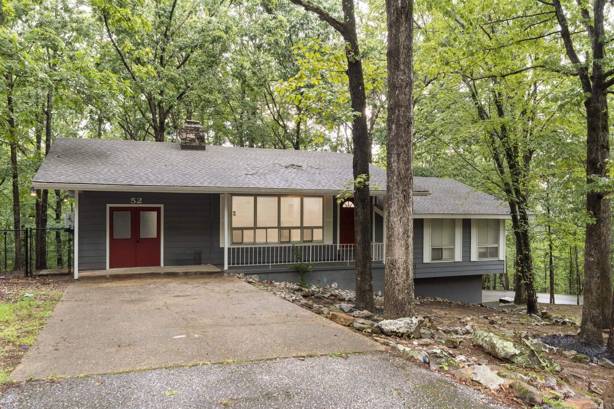 This beautifully remodeled home in Hot Springs Village offers the perfect blend of style, flexibility, and function. Every inch has been redone from floor to ceiling with quality finishes, including quartz countertops, new flooring, and a stunning rock fireplace that anchors the upper-level living space. The upper features an open-concept layout with the potential for a third bedroom, an oversized pantry, a dedicated laundry room, and a sleek step-in shower. A 4-season porch adds year-round comfort and extra living space, ideal for enjoying the peaceful surroundings. The lower level has its own private driveway and entrance, making it perfect for a rental unit, multi-generational living, or guest quarters. It includes 2 bedrooms, a spacious living area, full kitchen, dining area, patio and total privacy from the upper floor. Located in Hot Springs Village, the largest gated community in the U.S., residents enjoy access to 9 golf courses, 11 lakes, scenic walking trails, and more! A rare opportunity to own a fully updated, flexible home in a premier communityādon't miss it!