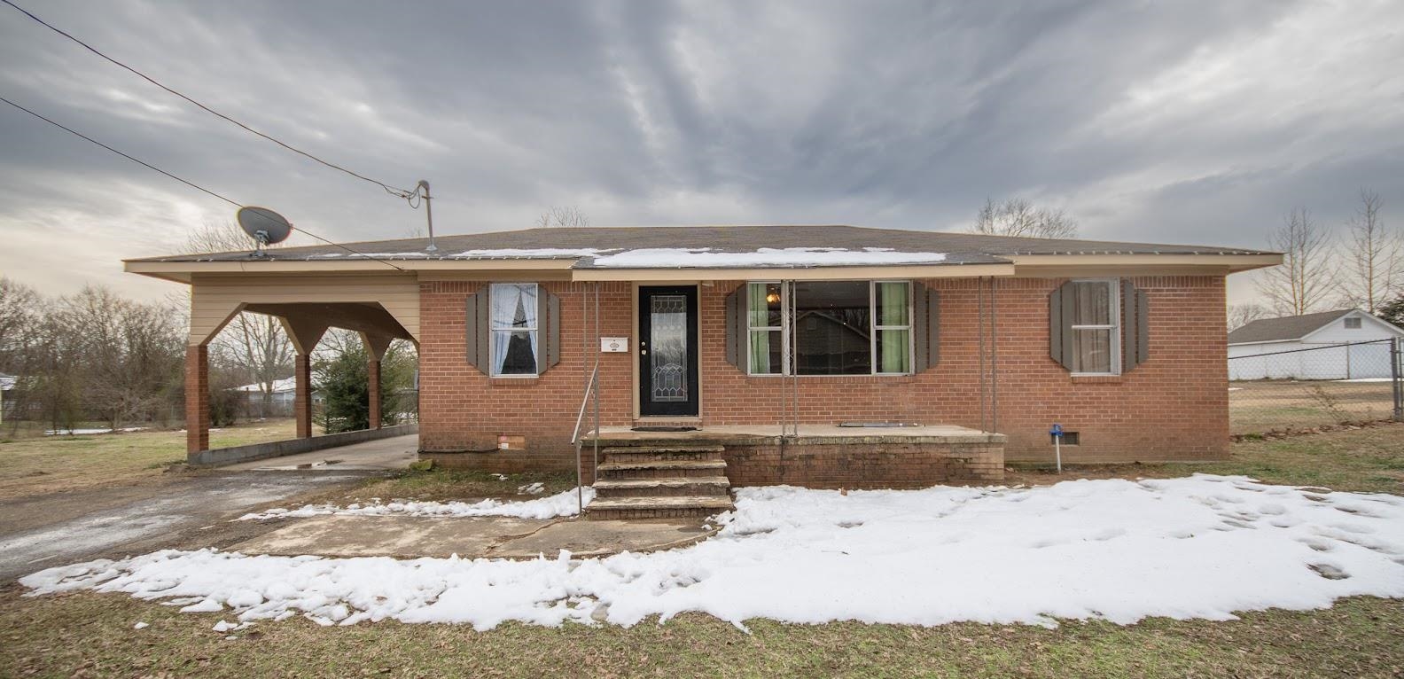 Updated home with new central heat & air unit currently being installed. Home is brick with metal roof for a maintenance free life style. Spacious living area with large picture windows offering natural lighting. Eat in Kitchen with many cabinets for storage. Three nice sized bedrooms. Laundry room with storage space. Carport, large fenced in back yard for your pets or children to play with garden area. Call for additional information and showing appointment.