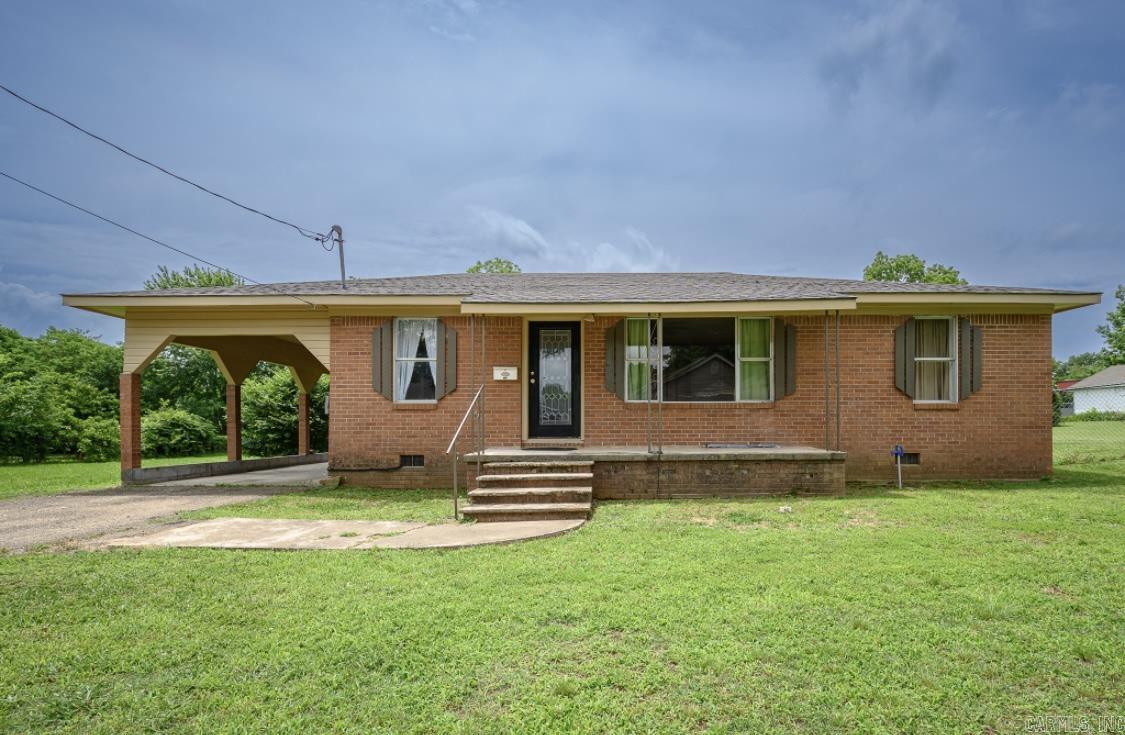 Updated home with new central heat & air unit currently being installed. Home is brick with metal roof for a maintenance free life style. Spacious living area with large picture windows offering natural lighting. Eat in Kitchen with many cabinets for storage. Three nice sized bedrooms. Laundry room with storage space. Carport, large fenced in back yard for your pets or children to play with garden area. Call for additional information and showing appointment.