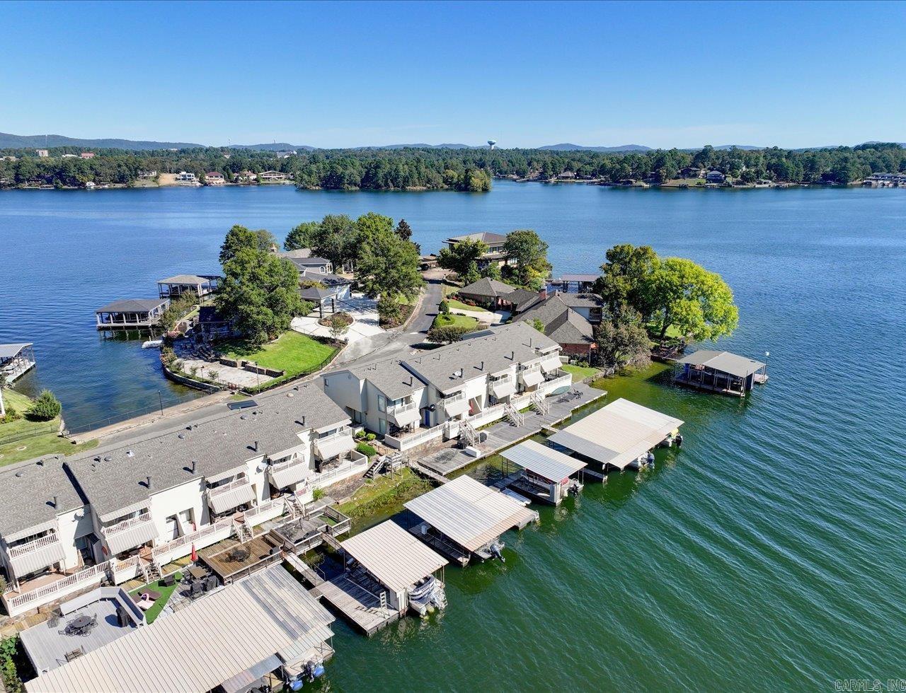 Long Island Park Condo. Best of the Best, Location and Amenties. Spacious 2B/2.5B, Being Sold Turn Key. All Personal Property included, along with Covered Boat Dock, Just Steps from Back Door.. Condo is Spotless, Lovingly Maintained and has had Many Updates, including Complete HVAC System, Dishwasher, Disposal, etc. Outside There Are Two Covered, Attached Decks and a Large Deck on The Water, Along With Boardwalk. The Grounds Are Incredible and Include Swimming Pool, Gated Entrance, Boat Ramp and Private Street. And Views are Supreme. Lake Hamilton at it's Finest!