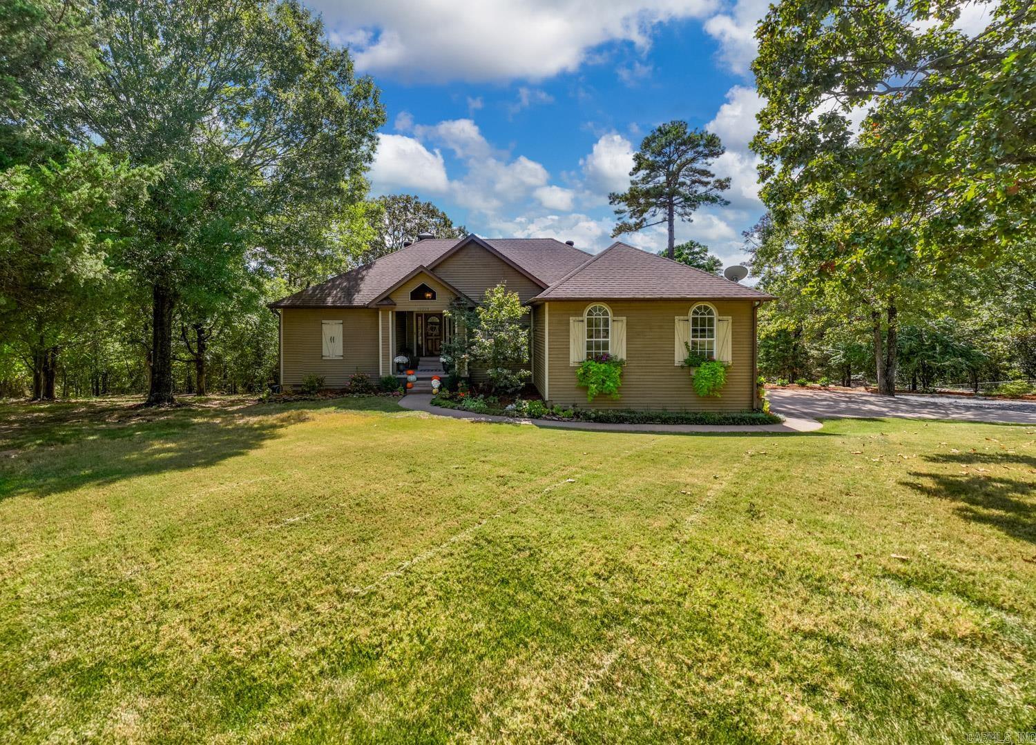 If you want a little country with uptown feel...THIS IS IT! Major Renovation 2019! Total Kitchen reno- countertops, backsplash, all new cabinets, appliances, plumbing, fixtures, & butler's pantry. Other updates include new flooring, paint, light fixtures, & high efficiency zoned HVAC system - 2019. Lives like one level - primary bedroom with ensuite includes soaking tub, walk-in shower, his/her sinks & an additional bedroom on this level. Downstairs you will find 2 more bedrooms, 1 full bath, game/bonus room. Enjoy the beautiful refurbished deck (2024) sitting amongst the treetops. Roof 2015. 40x40 Shop with 14'x14' overhead auto doors, additional 35x40 upper space for your man cave hangout. Shop is equipped with split units up & down. Outdoors you will find a great firepit area great for family nights or hosting! Don't miss the opportunity to call this place HOME!