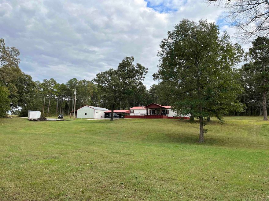 Introducing to you a secluded paradise nestled on 12 acres of wooded land with a small creek, abundant wildlife, and picture-perfect backdrop. Sit on the large covered deck and enjoy the peaceful sights and sounds of nature that surround you. This charming 3 bedroom, 2 bath home offers a relaxing retreat with many beautiful upgrades throughout. You will be greeted by a cozy wood fireplace to go along with 2 more sources of heat to insure you stay warm and comfy. The metal roof, less than 5 years old, and the HVAC, less than 8 years old, provides peace of mind for years to come. A open floor plan is ideal for your family/friends gatherings. The kitchen not only includes modern appliances but also offers beautiful wooden cabinets, lots of counter space, and a breakfast bar for those casual meals.  The property boasts a 3 bay detached carport, ideal for storing vehicles and outdoor equipment. Additionally, a 36x30 workshop awaits, complete with heating, cooling, water, 220 electricity, a kitchenette, and 2 overhead doors, making it a versatile space for any hobby or project.  Don't miss out on this unique property that truly has it all!  Requires buyer prequalify & 24 hour notice