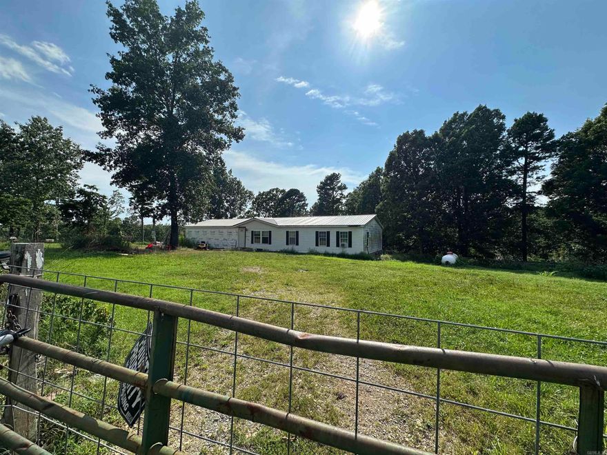 Mini-Farm & Homestead Opportunity-13.71 acres m/l near Yellville, AR! Looking for a peaceful country retreat with room to grow? This double-wide mobile home sits on 13.71 acres m/l of fenced land, offering the perfect setup for a mini-farm or homestead. Whether you dream of raising goats, cows, horses, or chickens, this property is already equipped with study fencing, a pond for livestock, and multiple lean-tos for shelter.  Envision the possibilities! The sub-floors have been completely redone, & some building materials are included, giving you a blank canvas to customize the space to your needs. A cozy country getaway or a full-time homestead, this home is ready for your finishing touches. Property comes with electric & shared well. Nestled in the rolling Ozark hills with beautiful views open pastureland and short drive from Yellville.