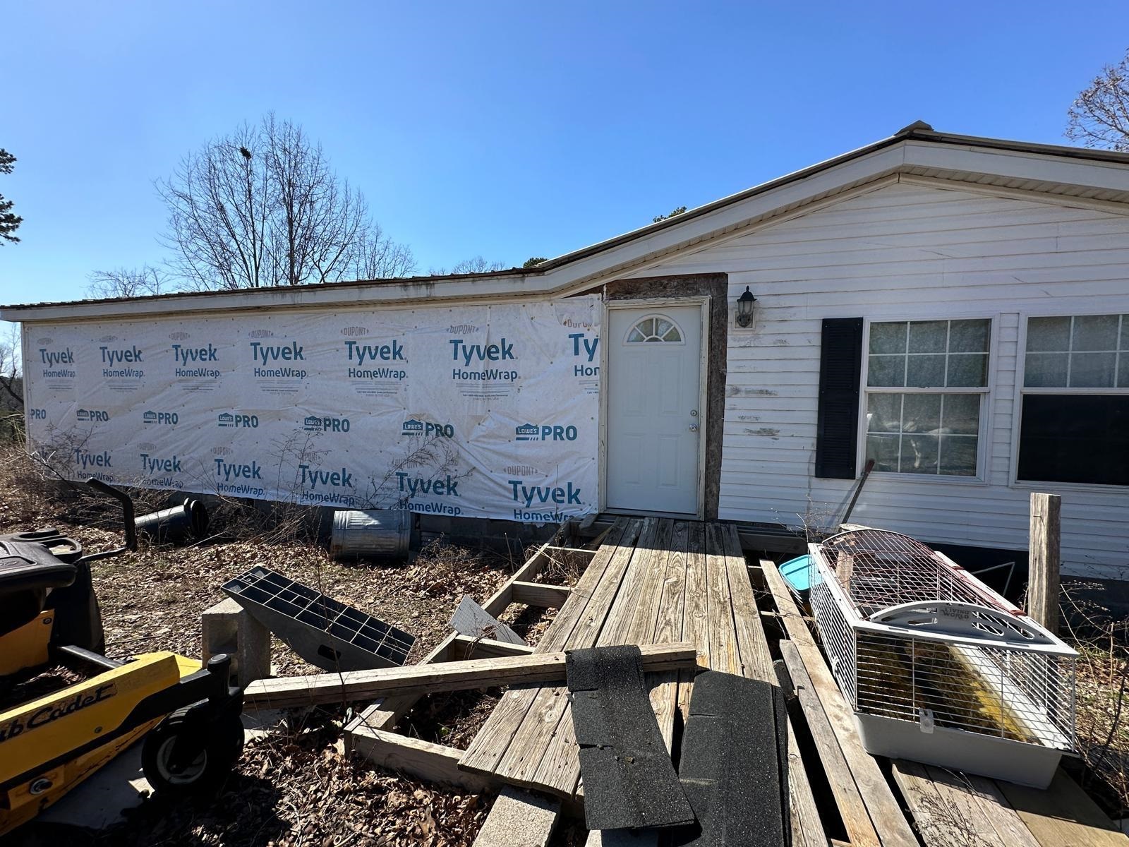 Mini-Farm & Homestead Opportunity-13.71 acres m/l near Yellville, AR! Looking for a peaceful country retreat with room to grow? This double-wide mobile home sits on 13.71 acres m/l of fenced land, offering the perfect setup for a mini-farm or homestead. Whether you dream of raising goats, cows, horses, or chickens, this property is already equipped with study fencing, a pond for livestock, and multiple lean-tos for shelter. Envision the possibilities! The sub-floors have been completely redone, & some building materials are included, giving you a blank canvas to customize the space to your needs. A cozy country getaway or a full-time homestead, this home is ready for your finishing touches. Property comes with electric & shared well. Nestled in the rolling Ozark hills with beautiful views open pastureland and short drive from Yellville.
