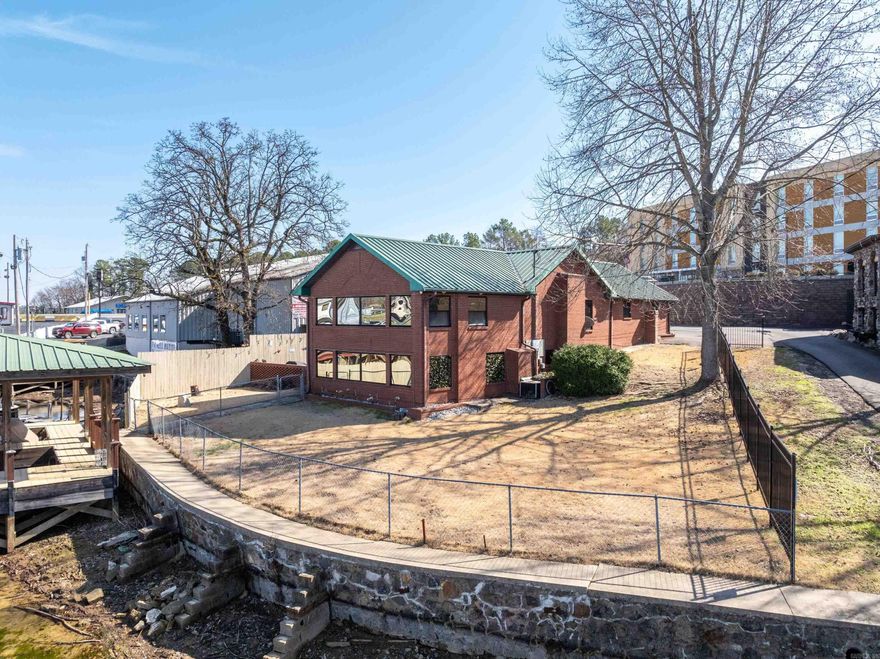 Excellent Location! Fully Furnished, Move In Ready! Situated on the serene waters of Lake Hamilton&#39;s main canal shores, just off marina circle in the highly sought 7 South area, walk to restaurants and marina area, remodeled with many updates, four bedroom, 2 1/2 baths with lots of storage, stainless appliances, nice patio area with outside stone fireplace on raised deck for entertaining family and friends, fenced yard, brick exterior,metal roof, 3 car garage, two stall covered boat dock with lift, concrete seawall, currently used as a VRBO, rents $350 per night during the week with 2 night minimum and $500 per night on weekends with 2 night minimum, Lakeside Schools. Check this one out!