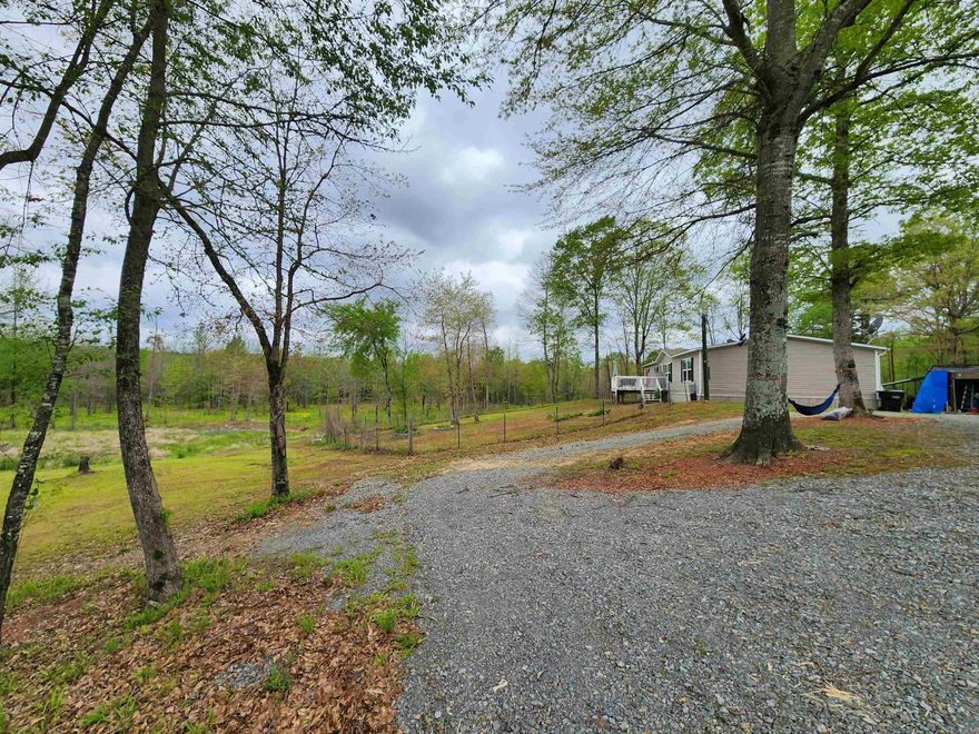 Country living at it's finest! 2018 Mobile Home sitting on 40.32 acres! Enjoy watching deer and wildlife from your front porch! Property is partially fenced with a creek that runs through it. You will find fruit trees, blackberry bushes, native & ornamental plants planted on the property. The 12x12 building in back with electricity does convey. Mobile Home is on a permanent foundation. Call for your tour today! Welcome HOME!