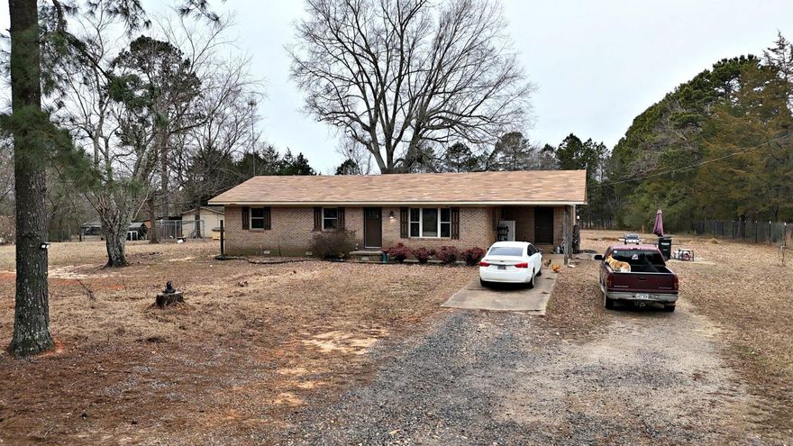 This charming 3-bedroom, 1-bath brick home offers 1,242 square feet of comfortable living space on 2.10 fully fenced acres, perfect for a small homestead or hobby farm. The land is completely enclosed with sturdy welded wire fencing and includes a barn equipped with rabbit and chicken pens, ready for your livestock or gardening needs. Recent updates include a newer roof and septic system, giving peace of mind and modern convenience. Enjoy the quiet country setting with nice views, yet appreciate the convenience of being just a short drive from town on a paved road. This property blends rural living with practical updates, ready for you to make it your own.