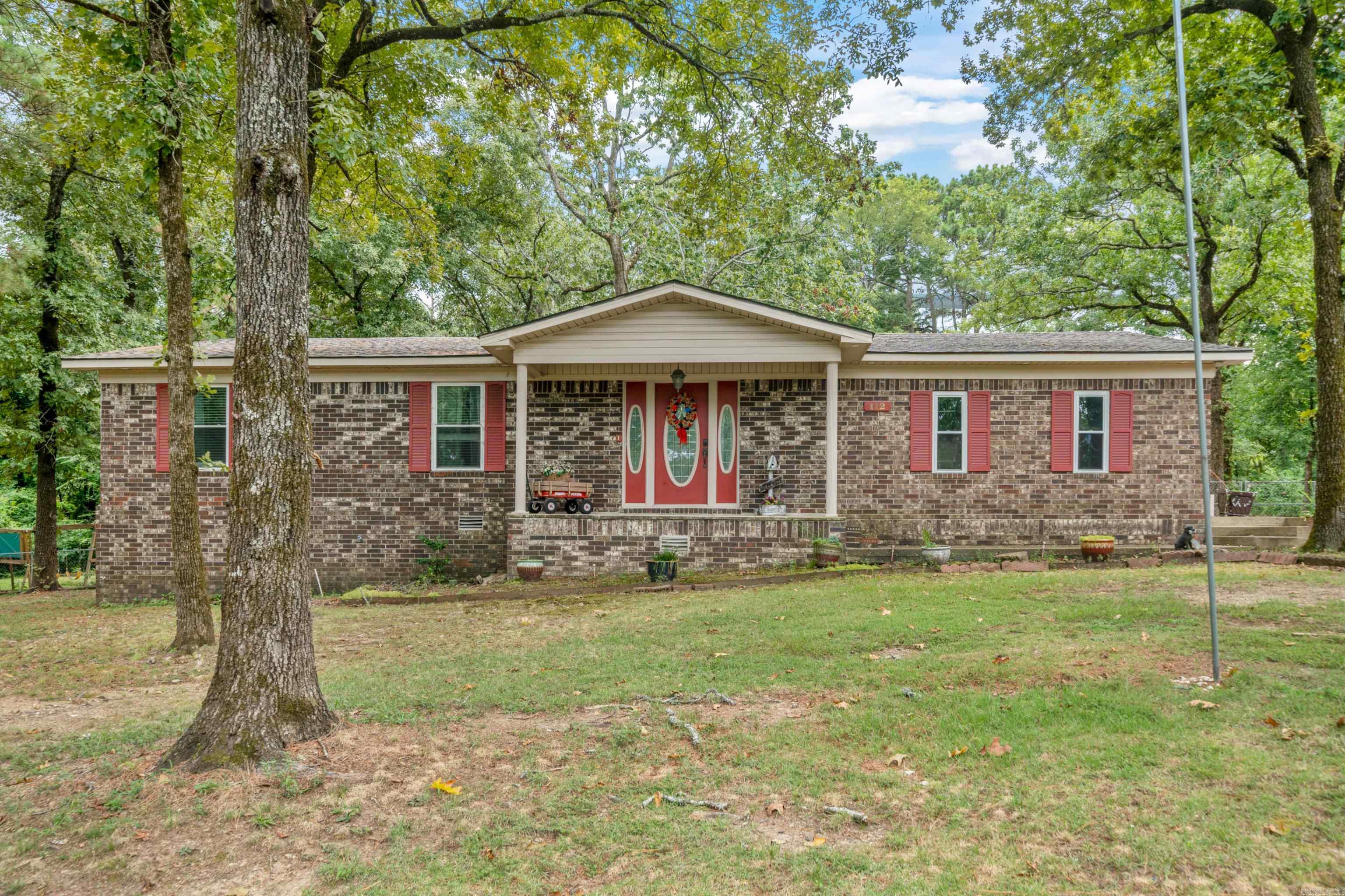 This 3 bed, 2 bath Lake Hamilton School District home on just under an acre is a must see! Tucked away on a low traffic lane just off Marion Anderson, this brick and siding home has a large lot, fully fenced & mostly flat back yard and covered patio (wired for hot tub) perfect for entertaining! Log outbuilding and garden shed both wired for electricity, and even a 30 amp RV hookup. Updates to the home include fresh paint, carpet, vinyl plank flooring, recessed lighting, GFCI's, new fixtures, smart garage door, 2 year old roof & soffits and a 6 month old water heater. Don't let this one pass you by! Call for your showing today!