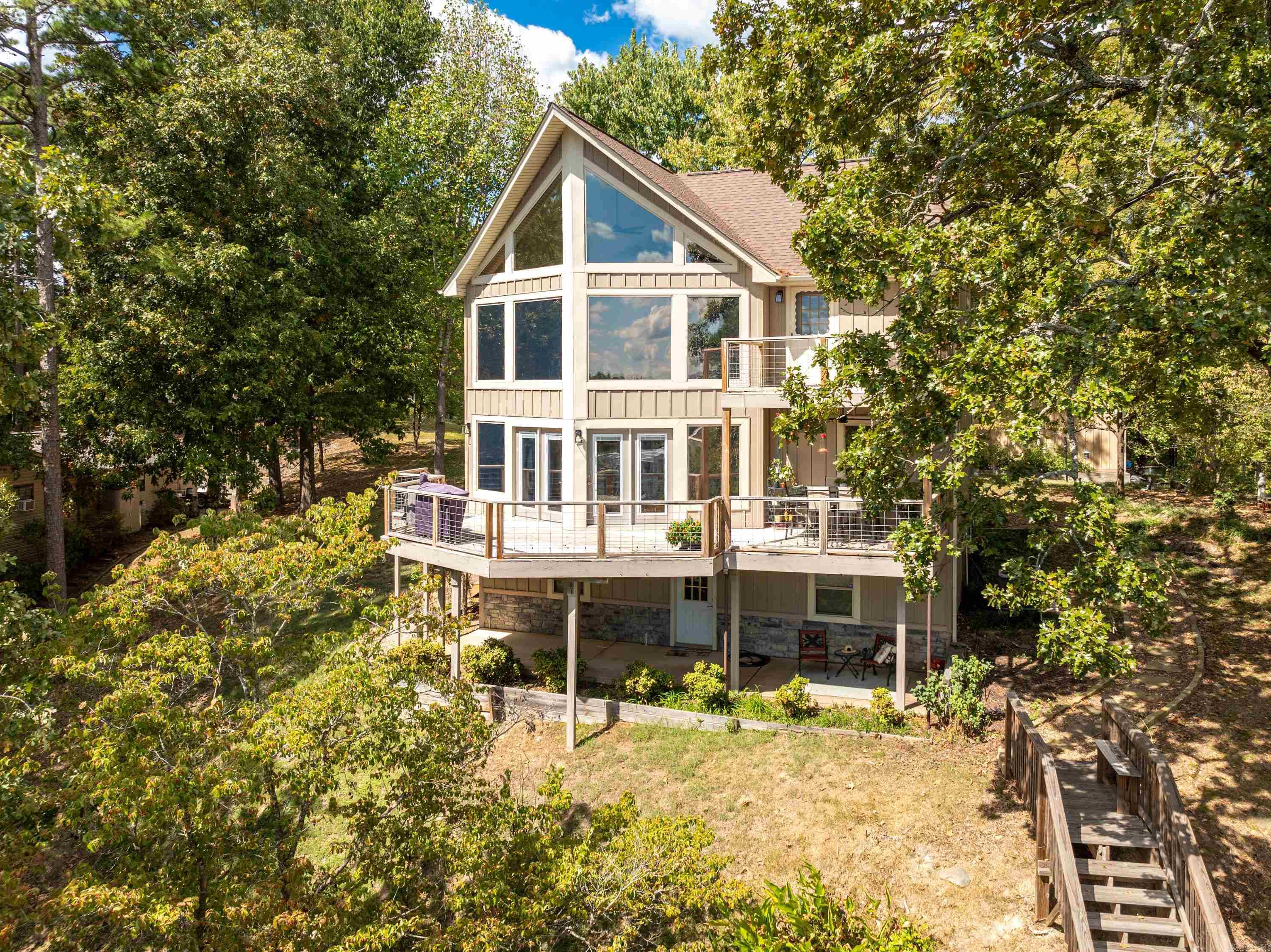 This exquisite custom-built, owner-occupied 3-bedroom, 2.5-bath residence spans an impressive 2,600 square feet and offers panoramicviews overlooking the beautiful Lake Hamilton. Enjoy the generous living space spread over three thoughtfully designed stories, perfectfor family gatherings or entertaining guests. Recent Updates: New roof installed in 2023, Six-year-old HVAC system (two units foroptimal comfort), New partial siding recently completed, All windows replaced with low-E gas for energy efficiency, keeping your homewarm in winter and cool in summer. The boat slip and steps to the water, completed in 2019, make launching your boat or enjoying wateractivities a breeze. Both decks were replaced in 2023, providing perfect spaces to relax while soaking in the stunning lake views. heproperty boasts a large 30x32 shop with two garage doors, equipped with PVC air compressor piping and 220 outlets to accommodateall your large electrical needsāideal for hobbyists or additional storage. Nestled in a tranquil setting, this home combines the serenity oflake living with easy access to local amenities. Whether you enjoy fishing, boating, or simply relaxing by the water, this property offe