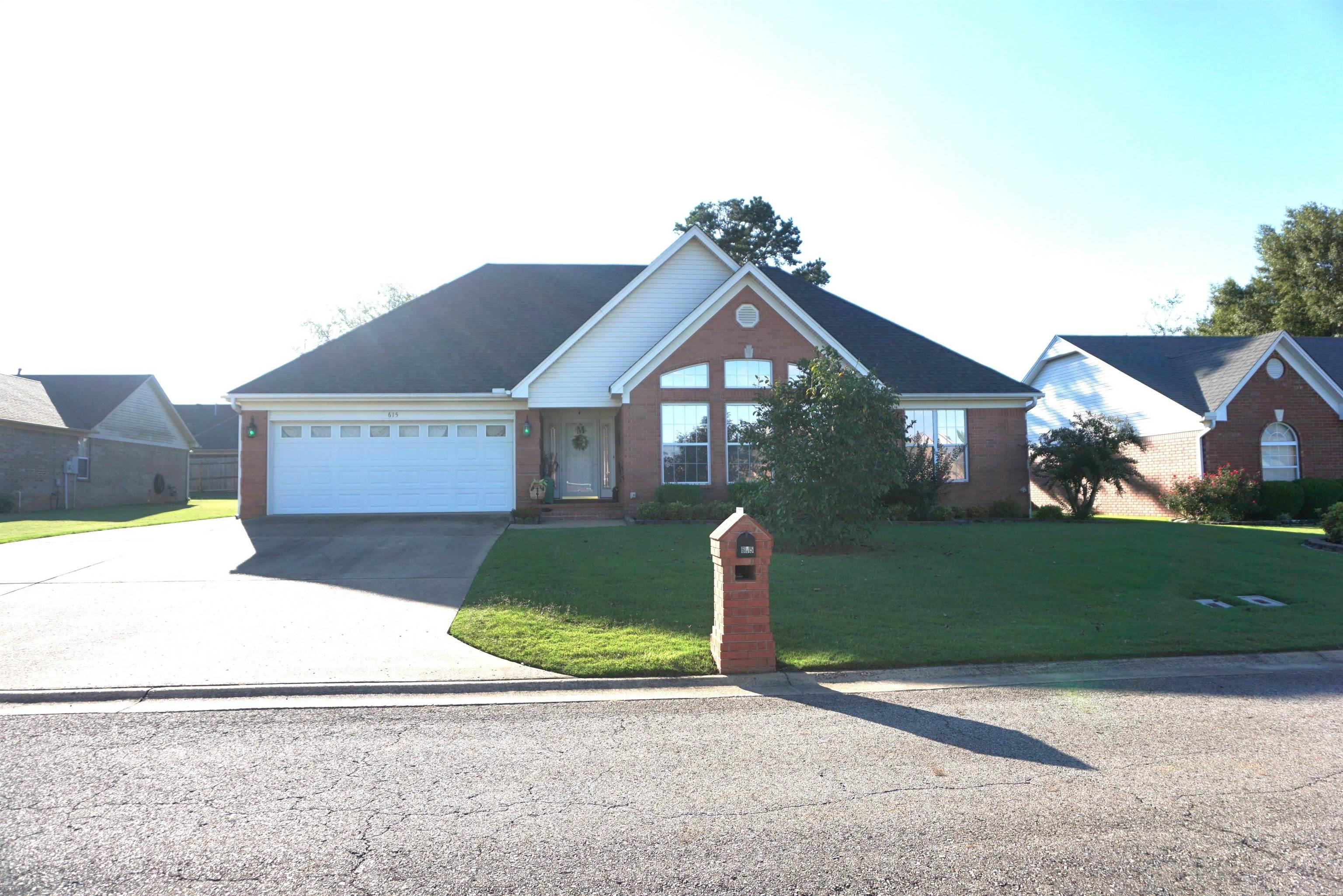Beautiful home with so many recent upgrades. New flooring, granite countertops in kitchen and bathrooms, new stone backsplash, and all stainless appliances. The roof was replaced in 2022. Lots of windows in the LR for natural lighting, but have been nicely tinted. Beautiful custom tile walk in shower with glass doors in the primary bathroom. All bedrooms have walk in closets and some have double walk in closets. Kitchen has a ton of pretty white cabinets and lots of storage. Nice area for a dining table that is very open to the living room. The concrete driveway was extended for extra parking. Covered back patio and beautiful landscaping and inground sprinkler system. Privacy fenced back yard with a wonderful brick storage building that has a welcoming front porch perfect for sitting and enjoying your private back yard. There is also a potting shed area behind the building for all you flower repotting people or can just be used for extra storage. The house is all electric but gas has been ran for the gas log fireplace for backup heat source. Sellers are downsizing and their condo will be ready the first week of November so the closing date has to be on November 7th or after.