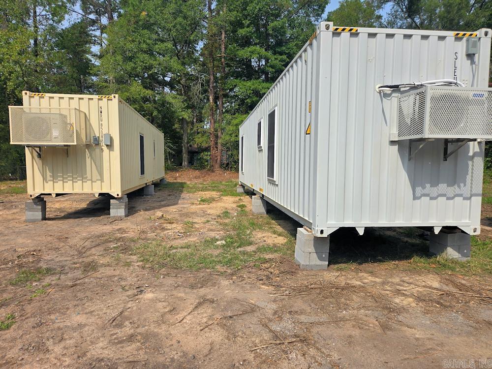 Two new tiny homes on .85 acre corner lot in Watson Chapel School District, near Pine Bluff. The tiny homes are 40' x 8' x 9' in diameter made from one-trip shipping containers. The first home is all electric and the second home has a gas stove. The homes will be sold together on the .85 acre lot. The homes were constructed in 2025 and will be ready for occupance as soonas utilities are hooked up. The permit for the septic system has been approved and will be installed soon. Each home has 1 bedroom and one bath with a walk-in shower. The kitchens have plenty of cabinet space. Mini Splits heat and cool the homes, plus a window units have been placed in the bedrooms for additional cooling. The walls have an R-17 Rating and the ceiling have an R30 Rating. There are washer and dryer connection for stacked units in both homes.