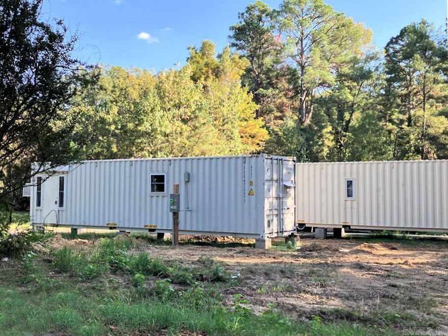 Two new tiny homes on a .85 acre corner lot in Watson Chapel School District, near Pine Bluff.  The tiny homes are 40' x 8' x 9' in diameter made from one-trip shipping containers.  The first home is all electric and the second home has a gas stove.  The homes will be sold together.  The homes are ready for occupancy as soon the septic system is connected.  The new septic system has been installed.    Each home has 1 bedroom and one bath with a walk-in shower.  The kitchens have plenty of cabinet space.  Mini Splits heat and cool the homes, plus window units have been placed in the bedrooms for additional cooling.  The walls have  R-17 Ratings and the ceilings have R30 Ratings.  There are washer and dryer connections for stacked units in both homes.