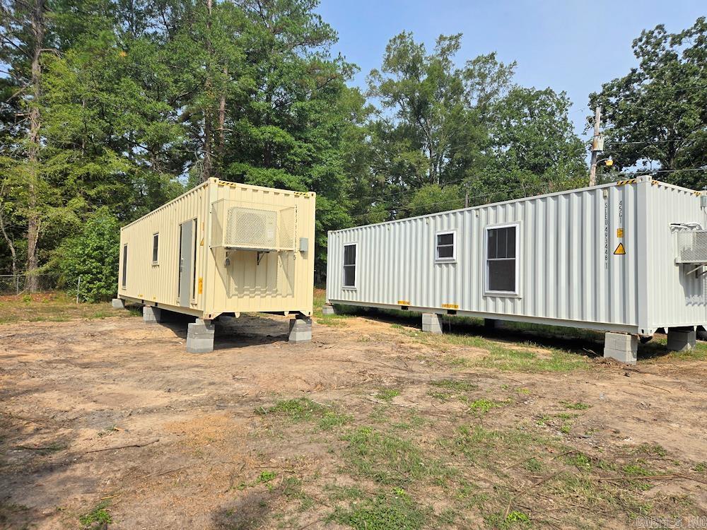 Two new tiny homes on .85 acre corner lot in Watson Chapel School District, near Pine Bluff. The tiny homes are 40' x 8' x 9' in diameter made from one-trip shipping containers. The first home is all electric and the second home has a gas stove. The homes will be sold together on the .85 acre lot. The homes were constructed in 2025 and will be ready for occupance as soonas utilities are hooked up. The permit for the septic system has been approved and will be installed soon. Each home has 1 bedroom and one bath with a walk-in shower. The kitchens have plenty of cabinet space. Mini Splits heat and cool the homes, plus a window units have been placed in the bedrooms for additional cooling. The walls have an R-17 Rating and the ceiling have an R30 Rating. There are washer and dryer connection for stacked units in both homes.