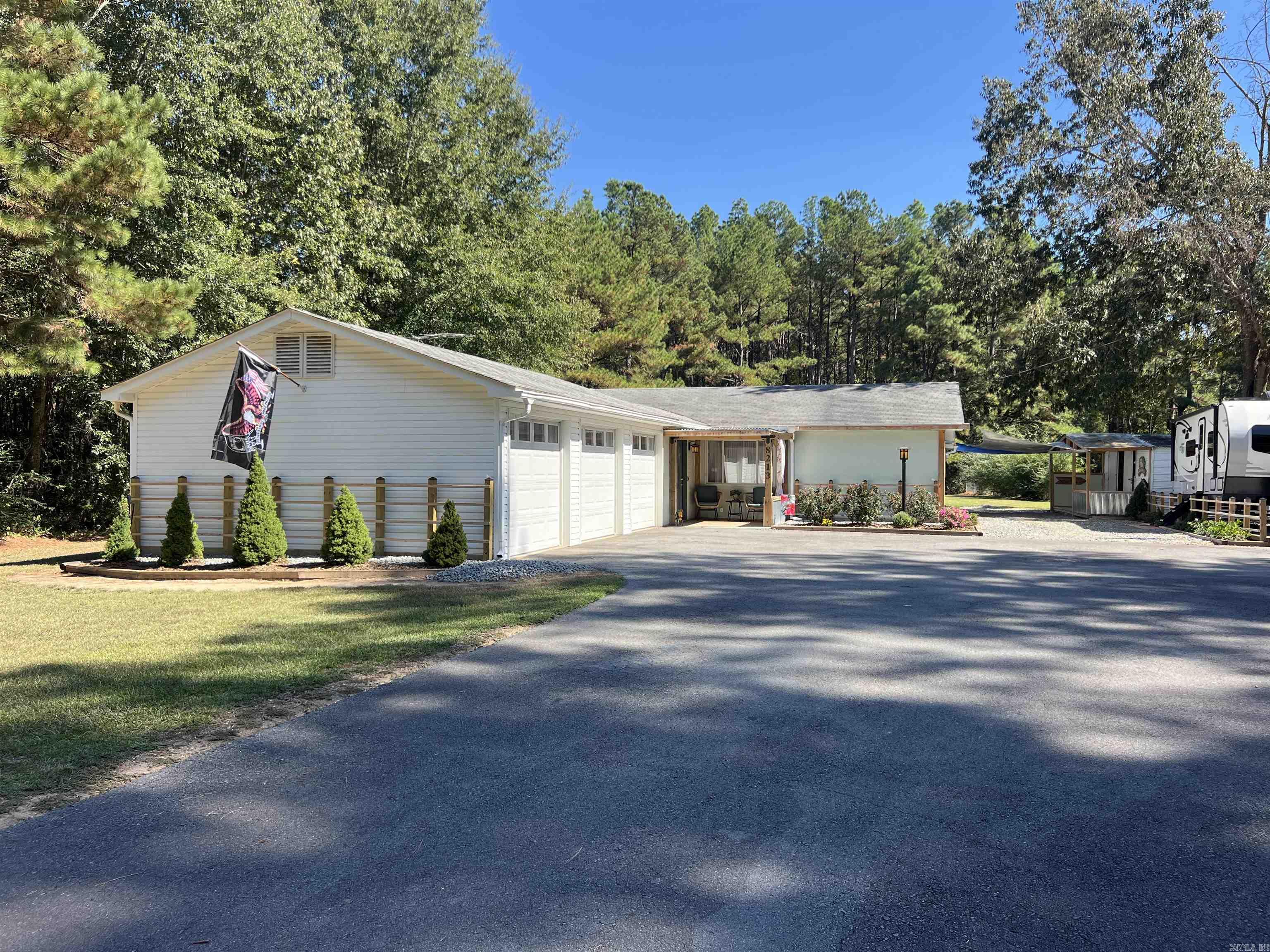 This beautifully remodeled 2-bed, 2-bath home sits on over an acre of land and features a versatile bonus room that could accommodate a third bedroom, study, or home office. It has a large sunroom currently being used as a sewing room. The stunning kitchen boasts brand-new appliances, countertops, backsplash, lighting, and flooring, while the updated bathrooms offer modern elegance. Enjoy year-round comfort with a new HVAC system and water heater and new roof. Outside, you'll find new landscaping, new septic system, a fenced yard, a storage shed with a porch, and a spacious back porch with a cozy sitting area. The home also includes built-ins, a hidden safe, a new front door, and a front-load washer & dryer. It has a three-car garage for an extra vehicle. Relax on the charming front porch and enjoy the peace and privacy of this beautiful property!
